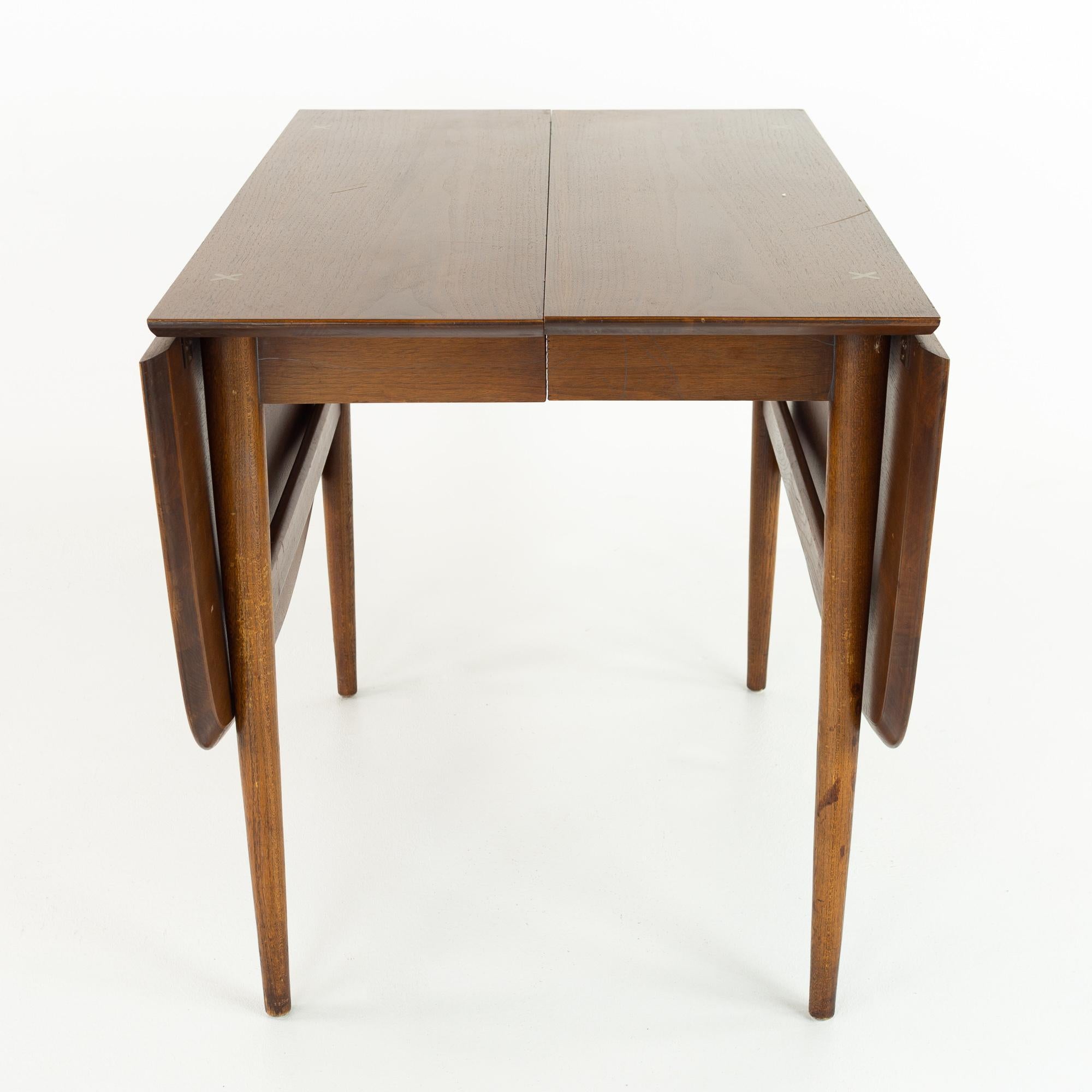 Merton Gershun for American of Martinsville mid century dining table with 2 leaves

This table measures: 61.5 wide x 40 deep x 29.75 inches high,with a chair clearance of 25.5 inches; each leaf is 12 inches wide, making a maximum table width of