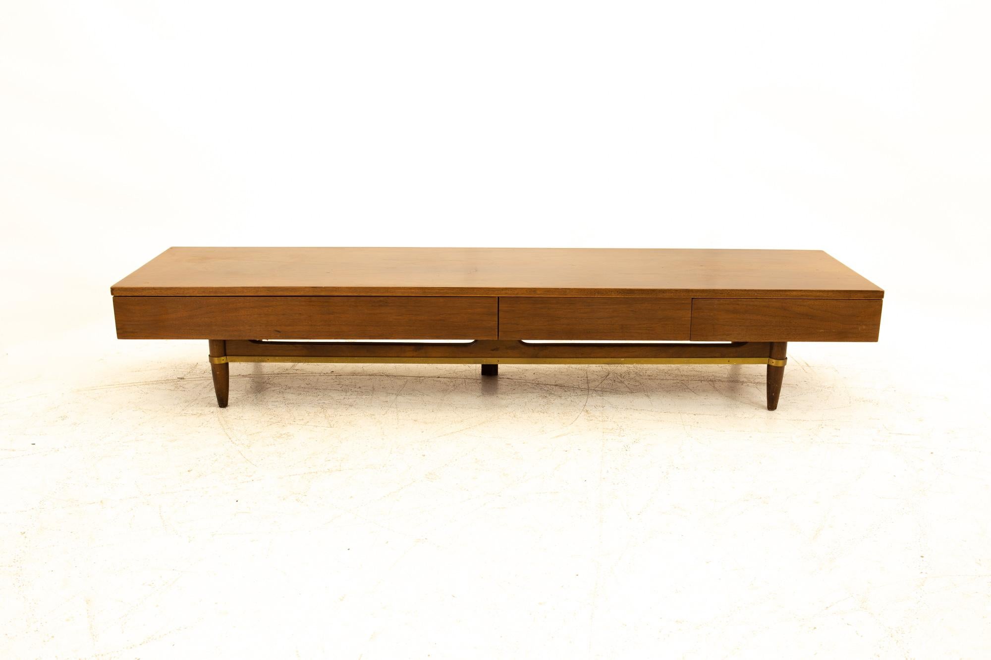 Merton Gershun for American of Martinsville Mid Century long 3-drawer walnut and brass bench
Bench measures: 72.25 wide x 18.5 deep x 12.75 high

All pieces of furniture can be had in what we call restored vintage condition. This means the piece is