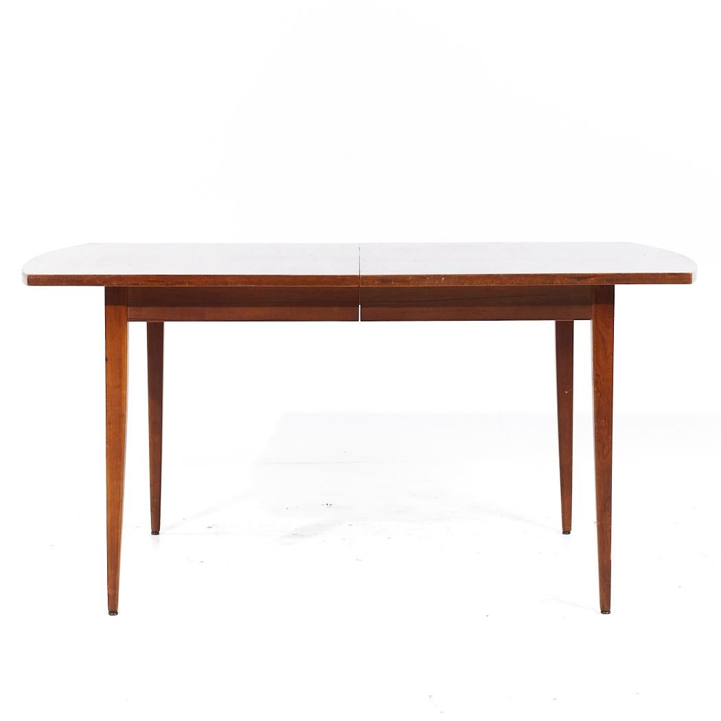Merton Gershun for American of Martinsville Mid Century Walnut Expanding Dining Table with 2 Leaves

This table measures: 62 wide x 40 deep x 30.5 inches high, with a chair clearance of 25.75 inches, each leaf measures 12 inches wide, making a