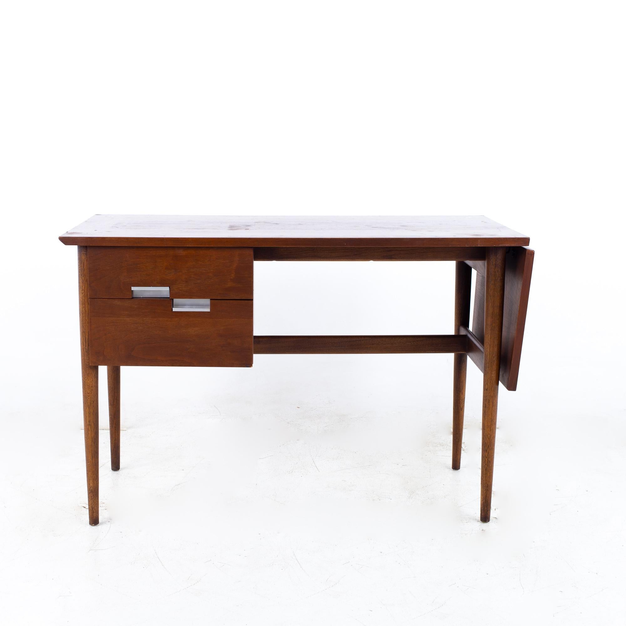 Merton Gershun for American of Martinsville mid century walnut dropleaf desk

Desk measures: 44.5 wide x 23 deep x 29.5 inches high, with a chair clearance of 26.25 inches; when expanded the desk is 58 inches wide

?All pieces of furniture can