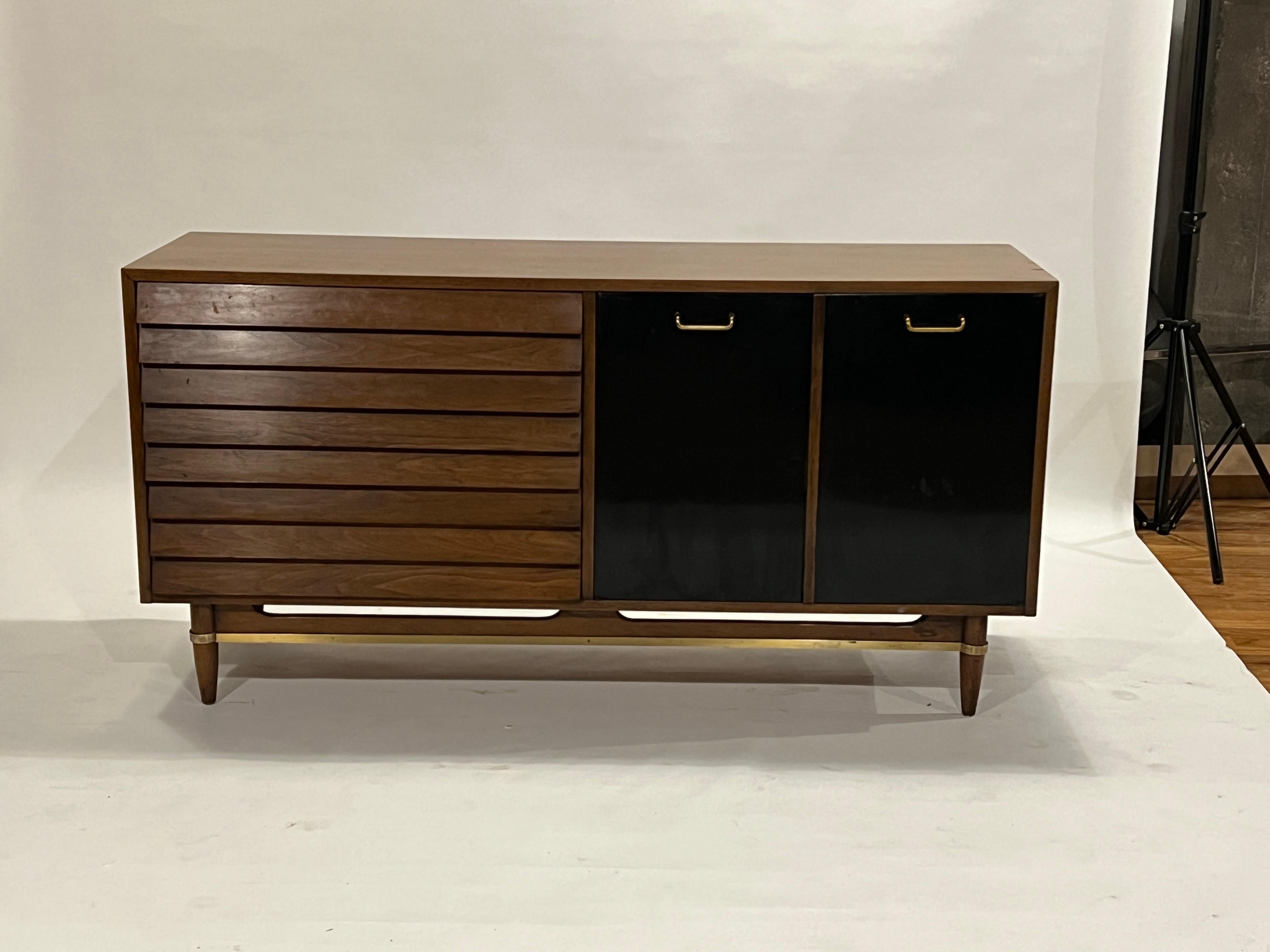 Mid-Century Modern low boy dresser by Merton Gershun for American of Martinsville in walnut with three long pull out drawers and three interior pull out drawers lacquered in off-white. The cabinet drawers are lacquered in black with a black glass