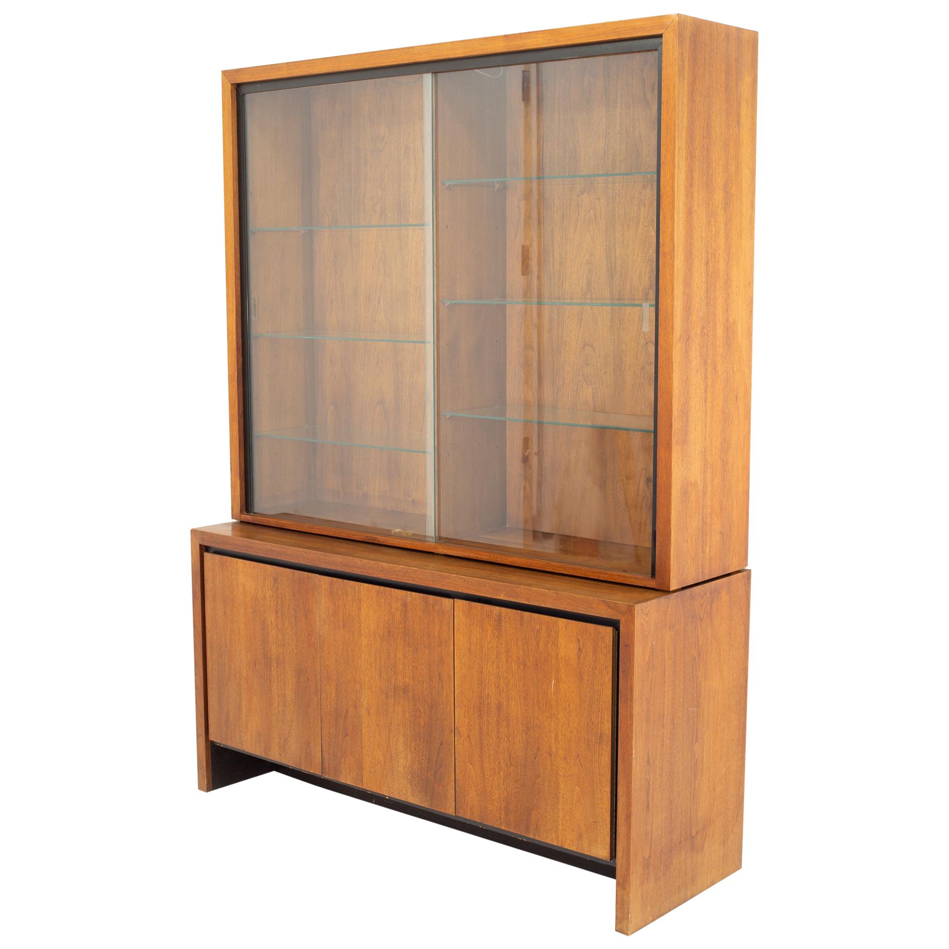 Merton Gershun for Dillingham mid century bookmatched walnut china cabinet.
Cabinet measures: 56.5 wide x 19 deep x 77.5 high

All pieces of furniture can be had in what we call restored vintage condition. That means the piece is restored upon