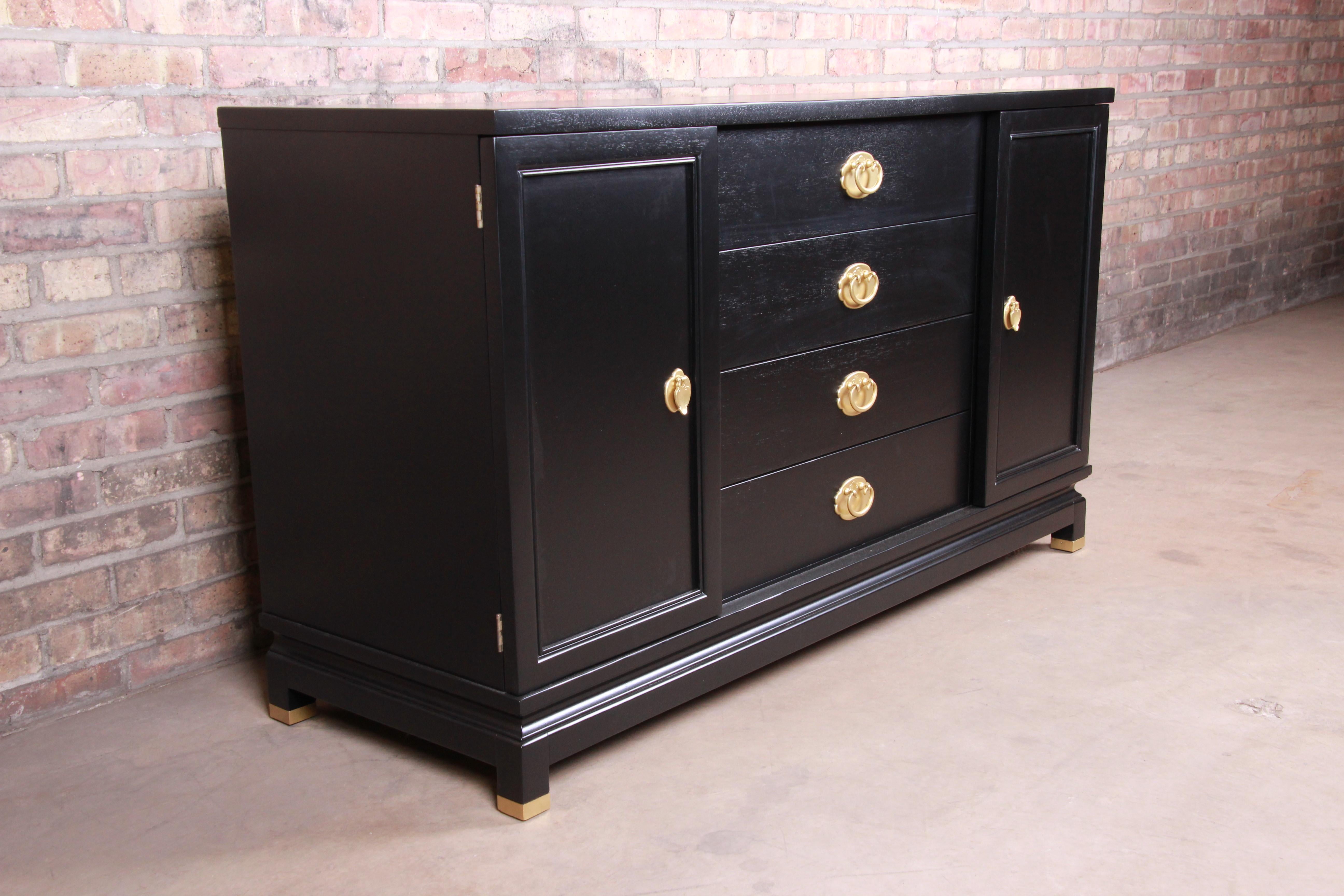 An exceptional midcentury Hollywood Regency chinoiserie sideboard credenza

By Merton Gershun for American of Martinsville

USA, circa 1960s

Black lacquered walnut, with Asian-inspired brass hardware and brass-capped feet.

Measures: 56