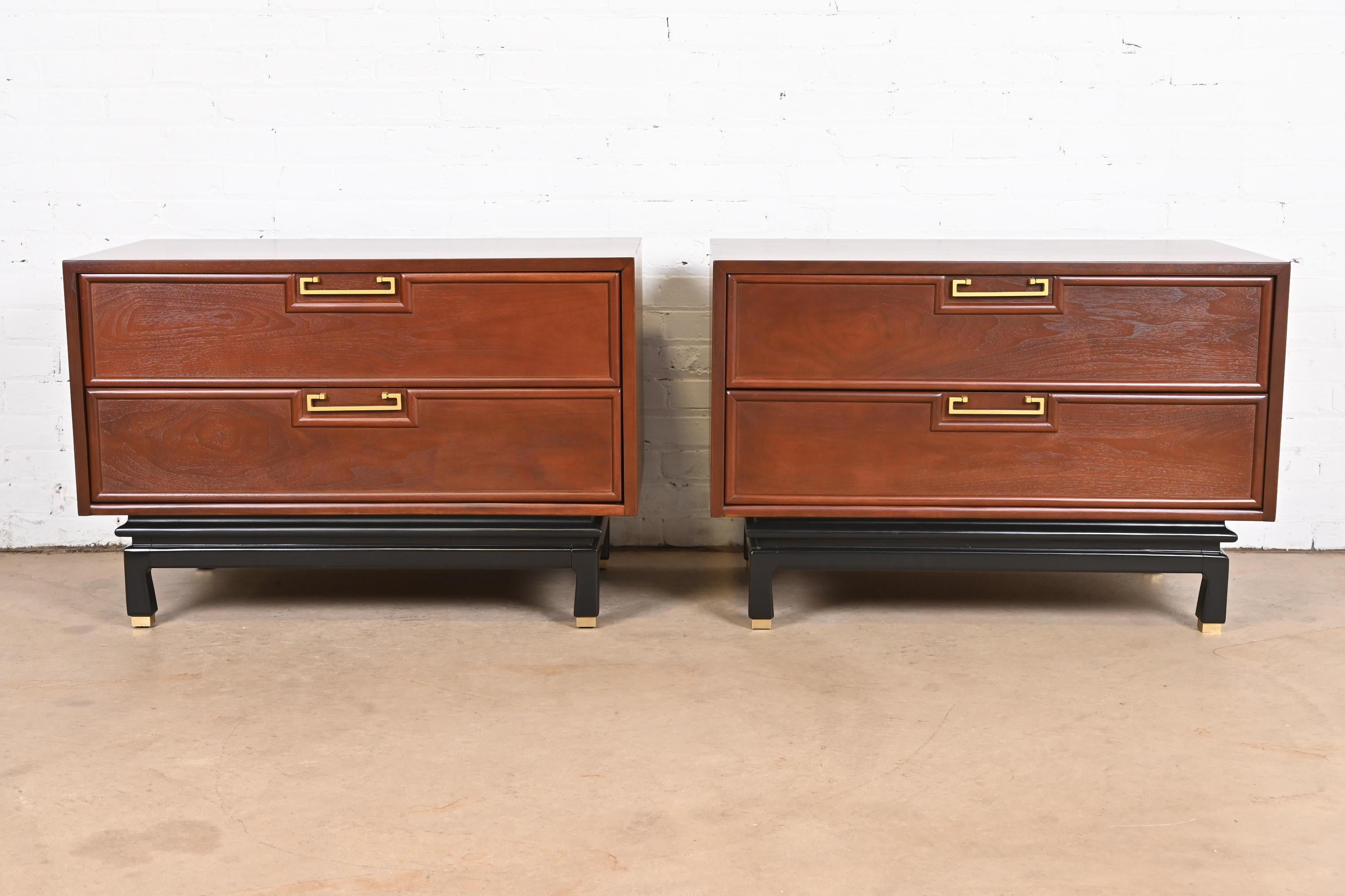 An exceptional pair of mid-century modern Hollywood Regency Chinoiserie chests of drawers or nightstands

By Merton Gershun for American of Martinsville

USA, 1960s

Walnut, with black lacquered legs, original Asian-inspired brass hardware, and