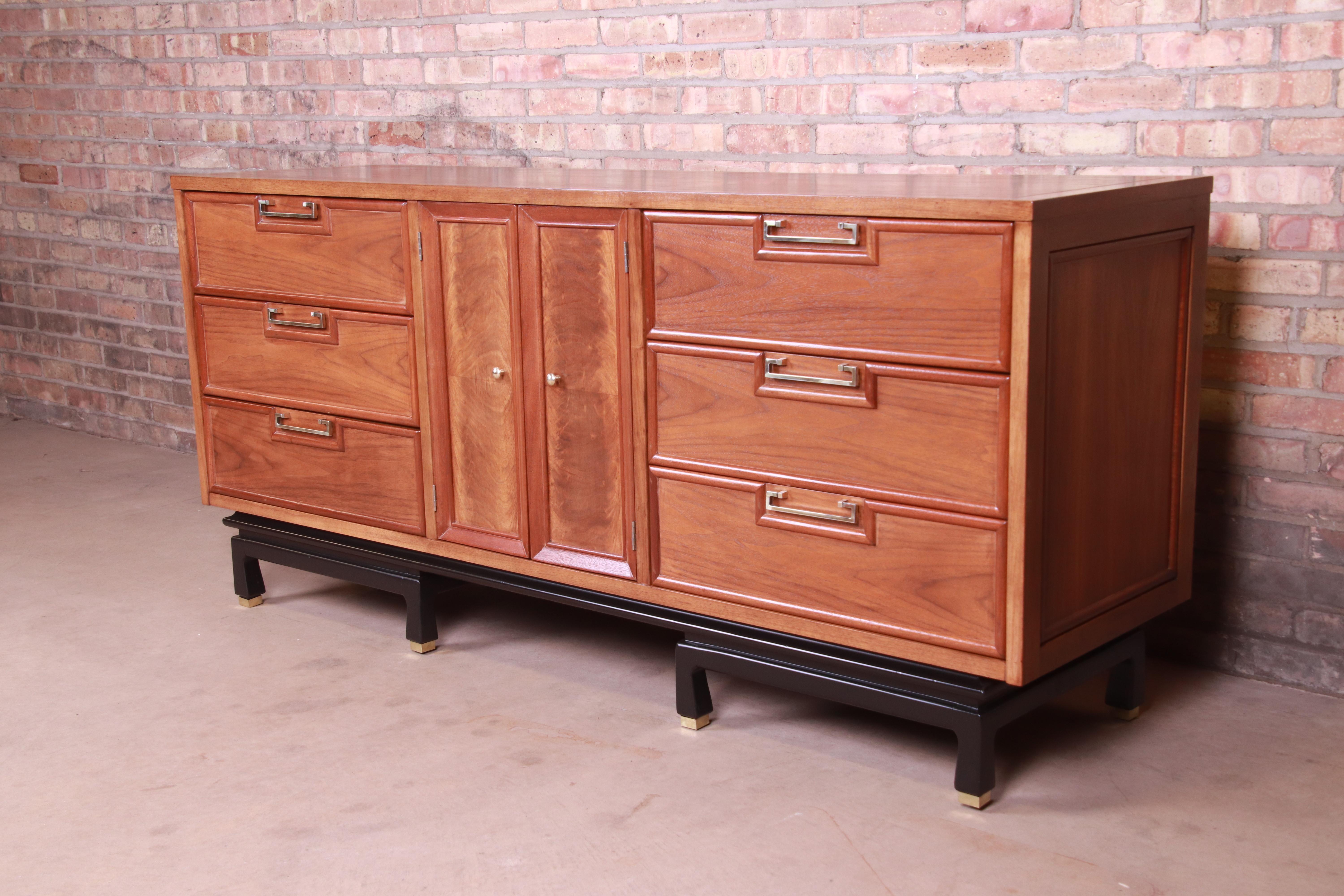 An exceptional mid-century modern Hollywood Regency Chinoiserie triple dresser or credenza

By Merton Gershun for American of Martinsville,

USA, 1960s

Book-matched walnut with burled walnut door fronts, ebonized base, original Asian-inspired