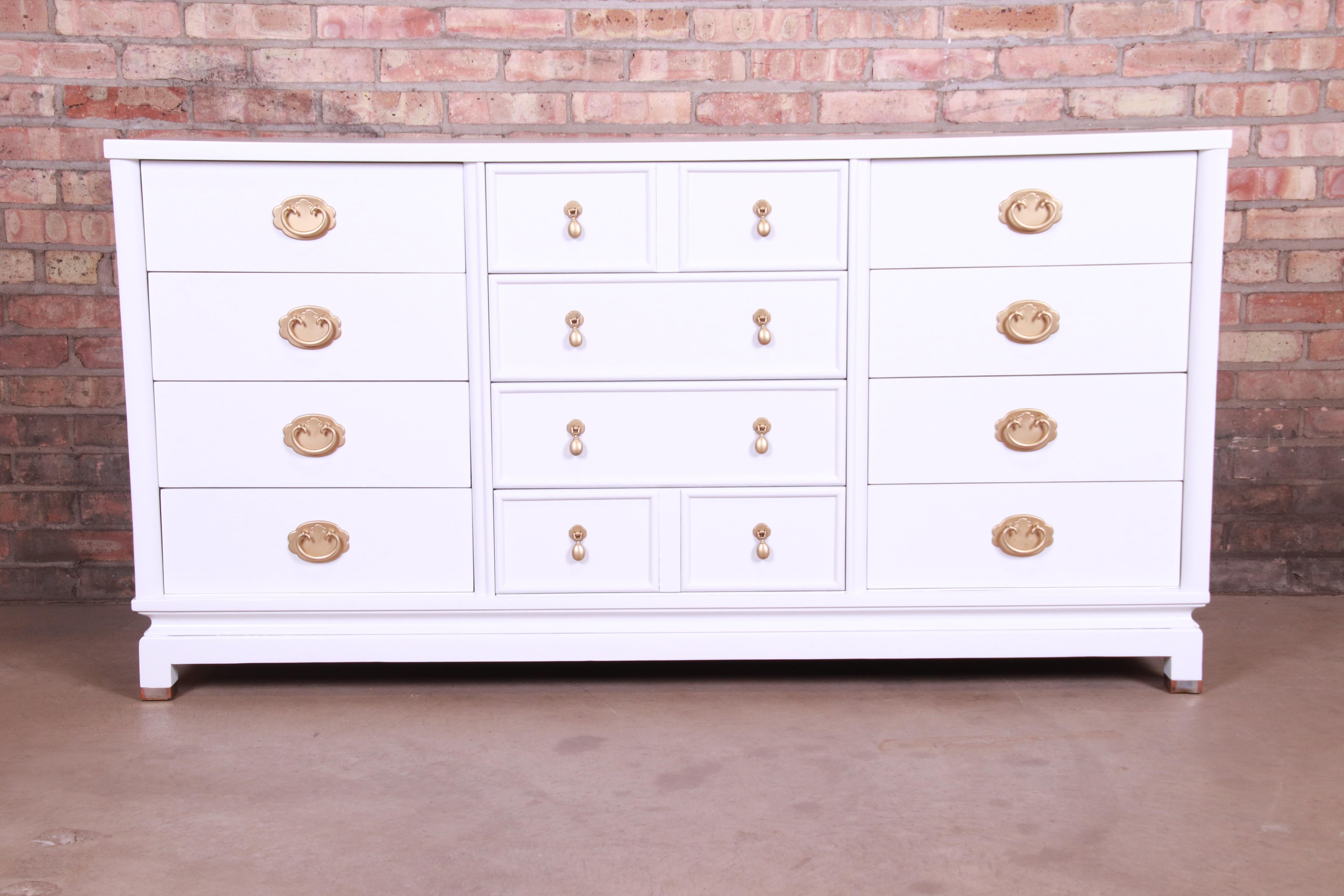 An exceptional Mid-Century Modern Hollywood Regency chinoiserie triple dresser or credenza

By Merton Gershun for American of Martinsville

USA, circa 1950s

White lacquered mahogany, with original Asian-inspired brass hardware.

Measures: