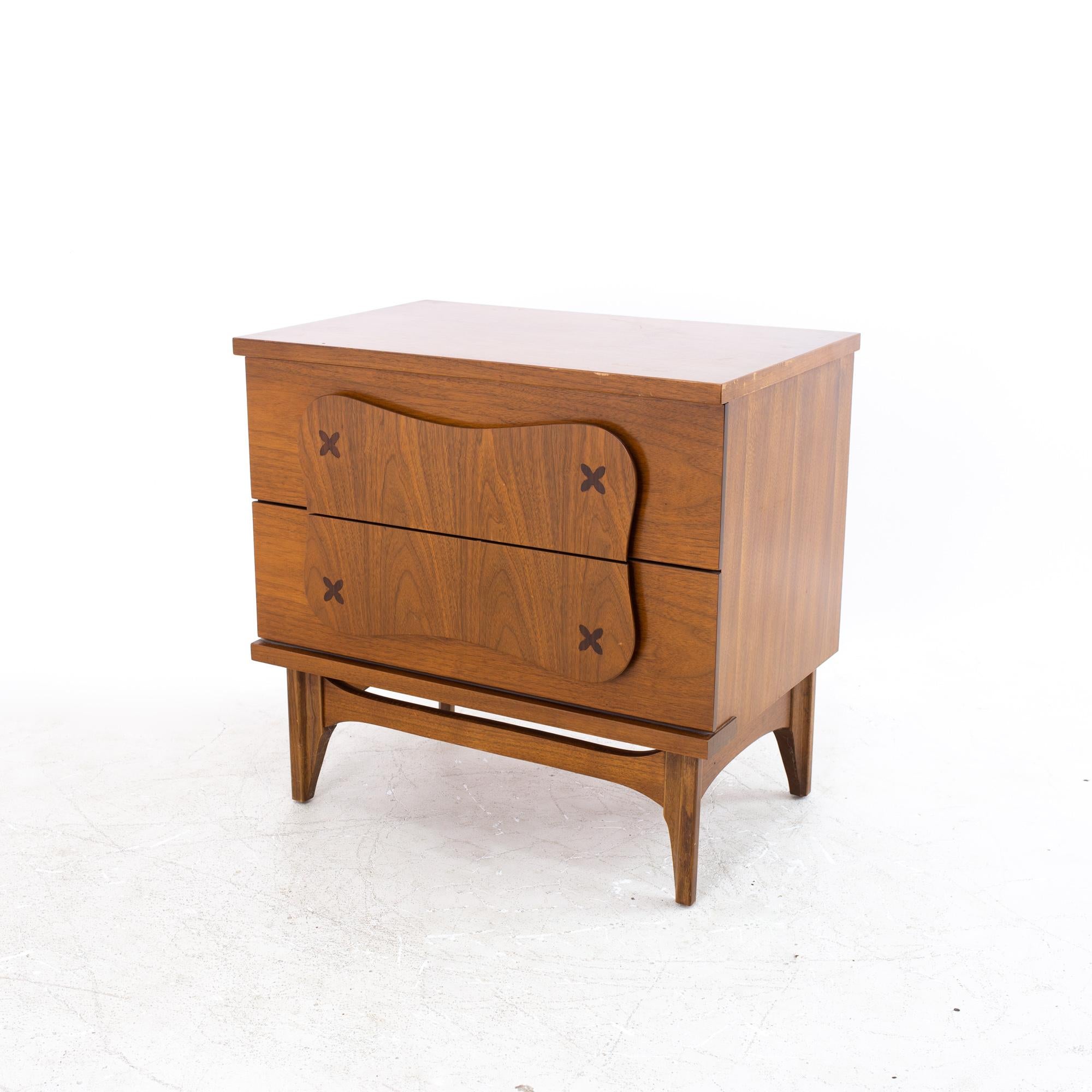 Merton Gershun style Bassett furniture mid century walnut nightstand.
Nightstand measures: 24 wide x 16 deep x 23.25 high

All pieces of furniture can be had in what we call restored vintage condition. That means the piece is restored upon