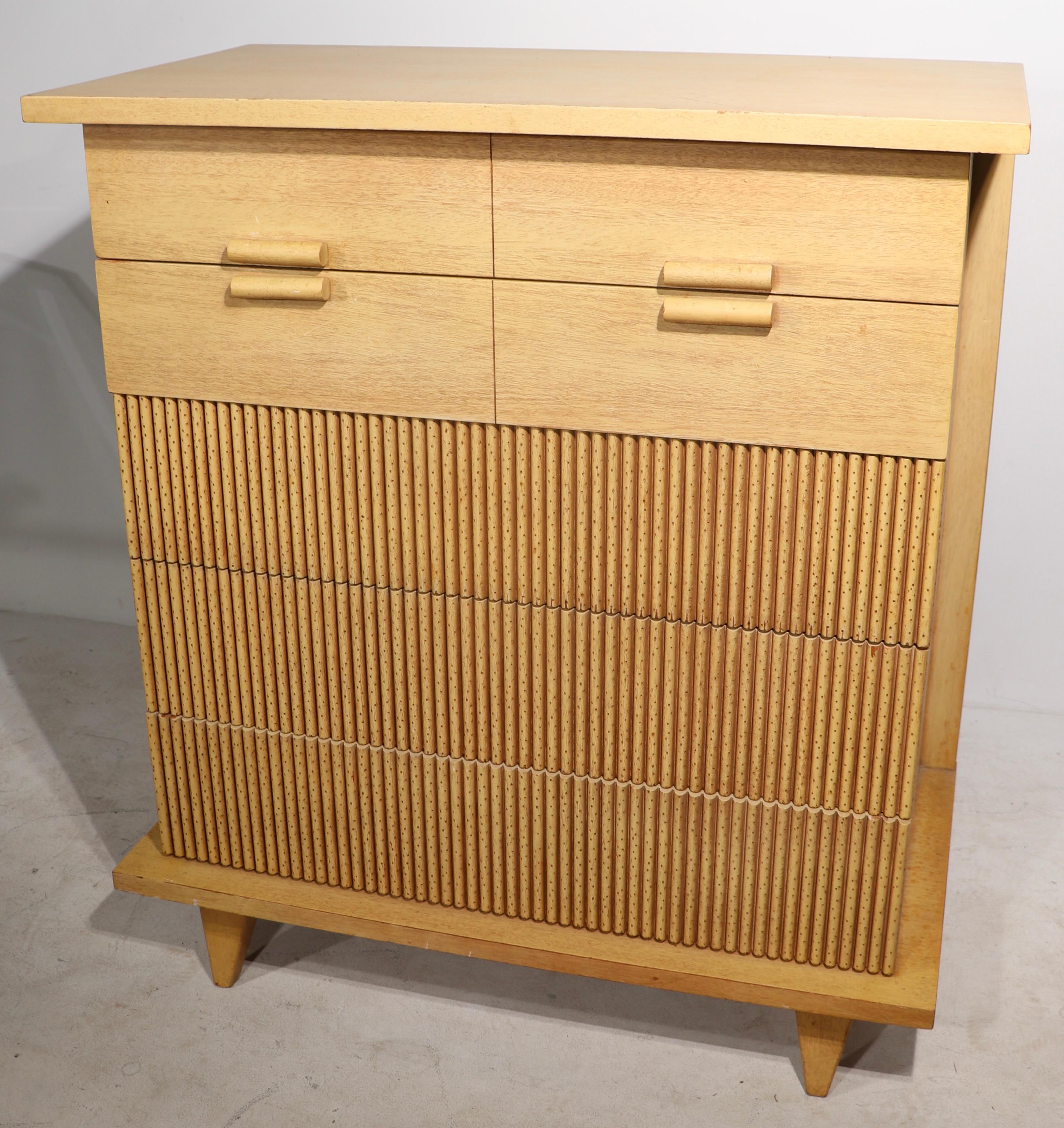 Chic and stylish 5 drawer dresser in bleached mahogany with decorative faux bamboo front. The chest features an architecturally inspired case, which surrounds the drawer fronts, creating a dimensional design element to the cabinet. From the sought