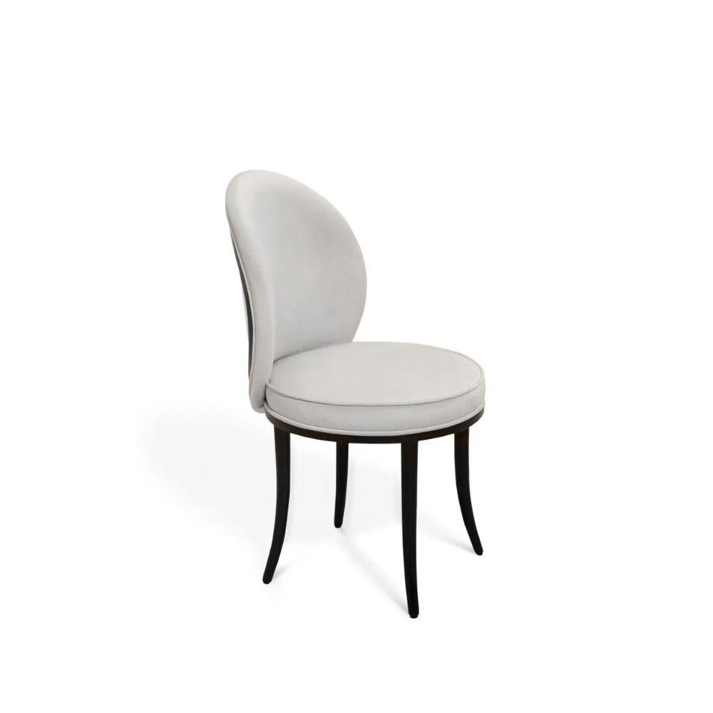Entertain in haute style with the Merveille Dining Chairs. Stunning design turn the outside back of this graceful chair into a wondrous work of art!

Materials & Finishes:
Seat Upholstery: Radiance Velvet Cream from the KOKET Textiles