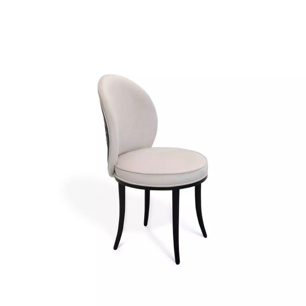 Entertain in haute style with the Merveille Dining Chairs. Stunning feathers turn the outside back of this graceful chair into a wondrous work of art!

Materials & Finishes
Seat Upholstery: Radiance Velvet Cream from the KOKET Textiles