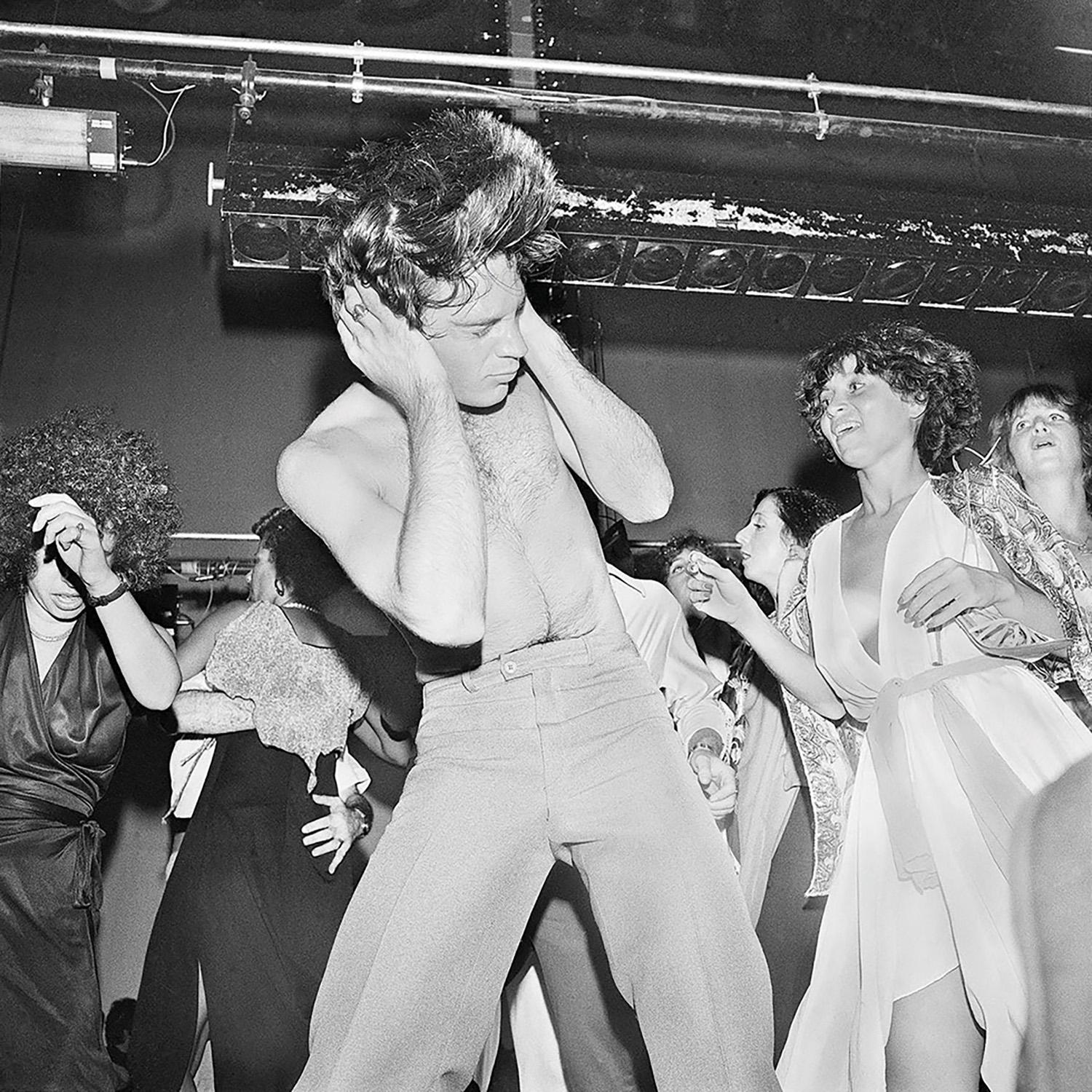 Meryl Meisler Black and White Photograph - JJ Holding Head as Hair Flies While Dancing with JudiJupiter, Studio 54, NY, NY