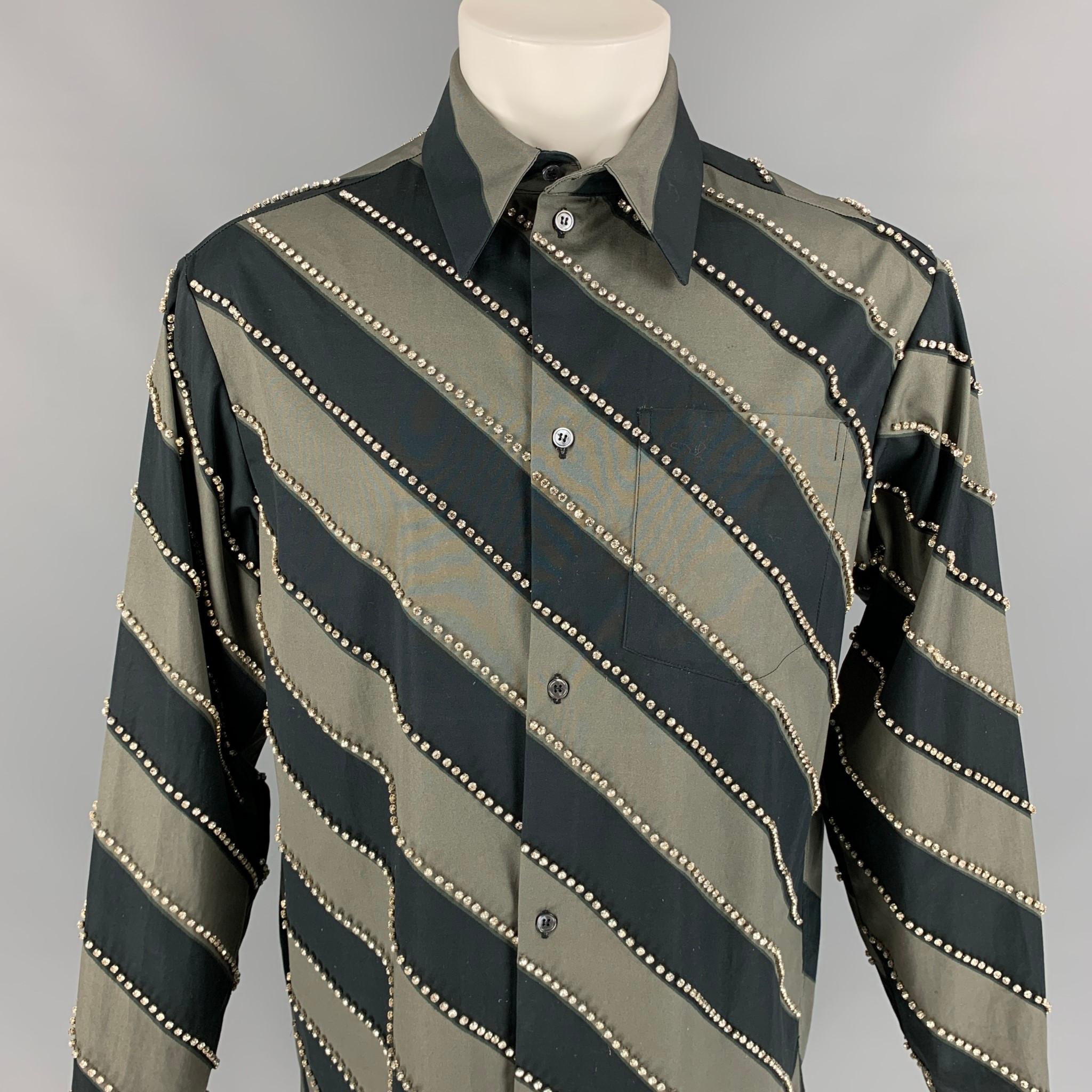 MERYL ROGGE long sleeve shirt comes in a grey & black diagonal stripe cotton featuring rhinestone details, pointed collar, patch pocket, and a buttoned closure. Comes with tags. Made in Italy.

Excellent Pre-Owned Condition.
Marked: 38
Original