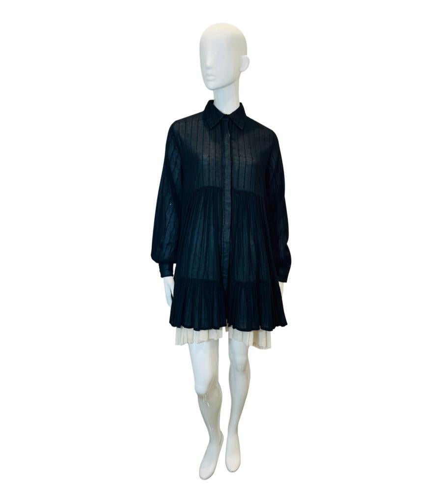 Mes Demoiselles Cotton Shirt Dress
Black mini 'Offy' dress designed with white petticoat detail.
Featuring ruffled bodice and fabric feathering accent.
Styled with long sleeves, classic collar, hidden centre button closure and loose silhouette.
Size
