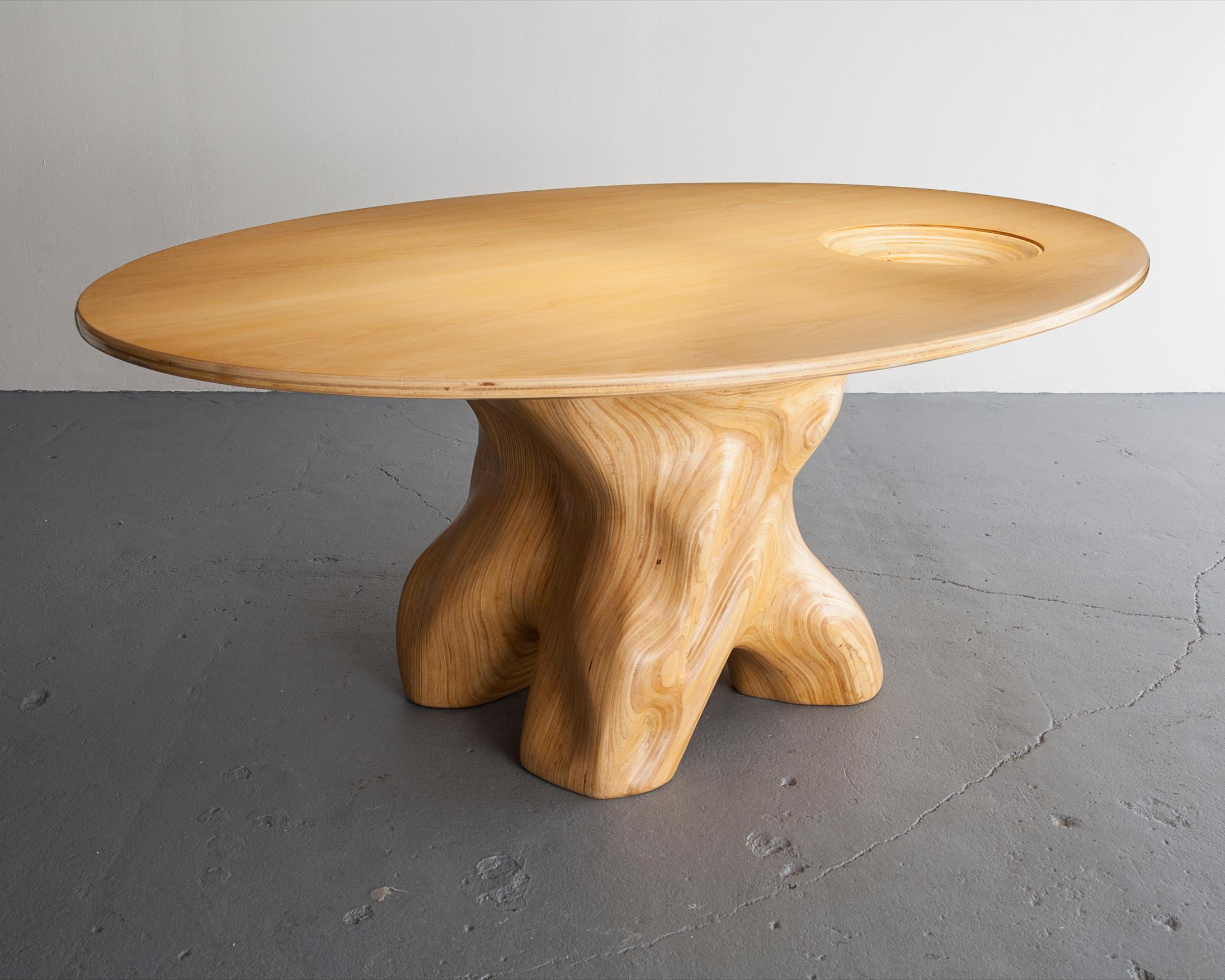 Mesa Baum oval table in stack-laminated sumauma wood with sculpted concave bowl and glass inset. Designed and made by Julia Krantz, Sao Paulo, Brazil, 2005.
 