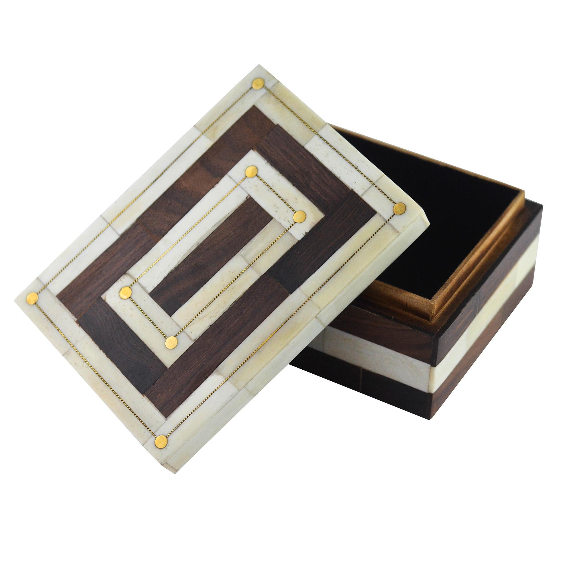 A brown and natural colored bone box with contrasting stripes. Features inlaid gold details.
 