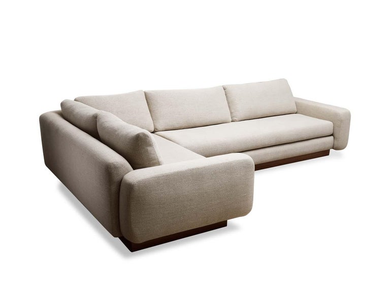 The Mesa Sectional is fully upholstered and features a walnut or oak plinth base. Dimensions: 120