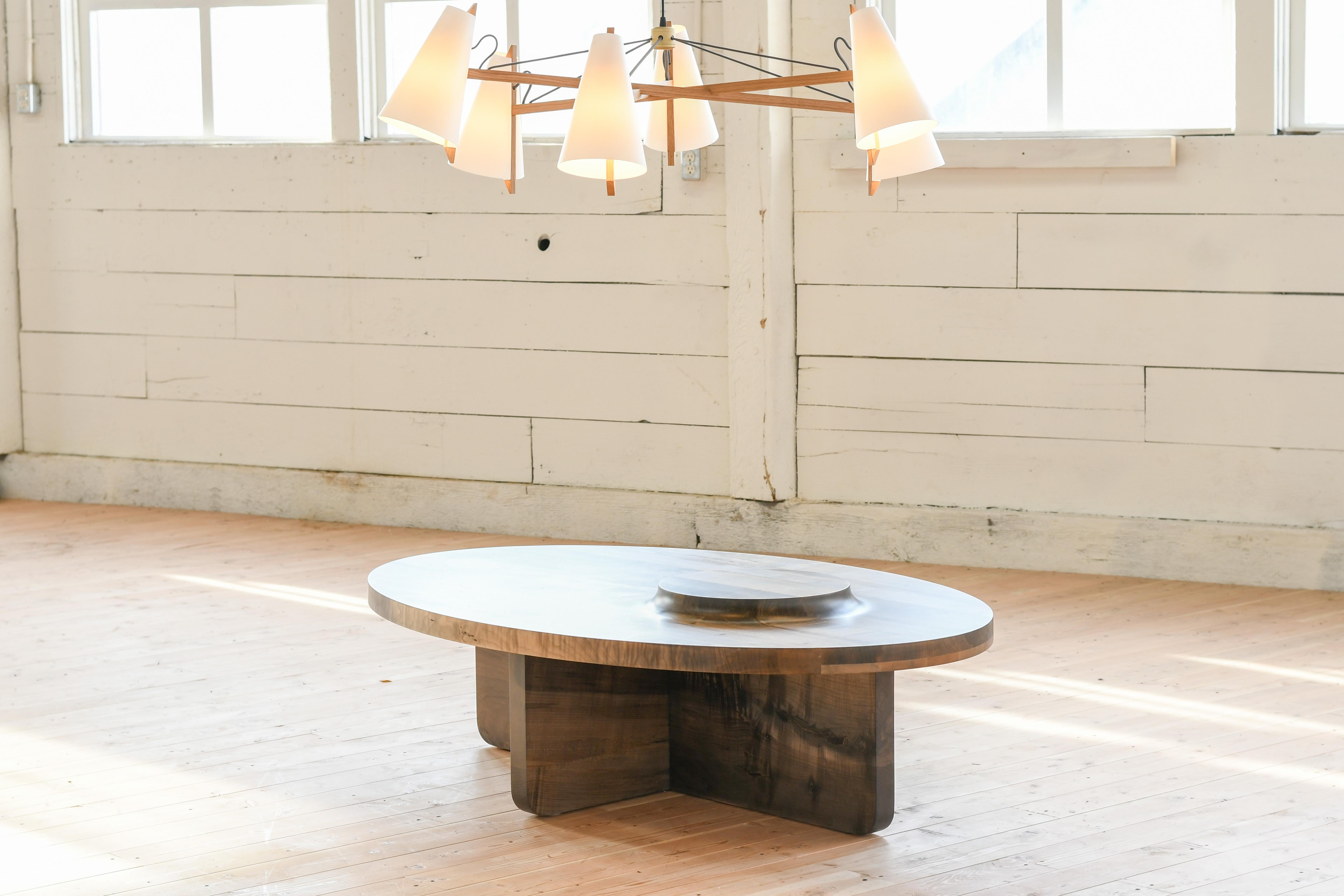 Hand carved custom wooden coffee table with an elevated Mesa portion. Shown in our oval version at 40