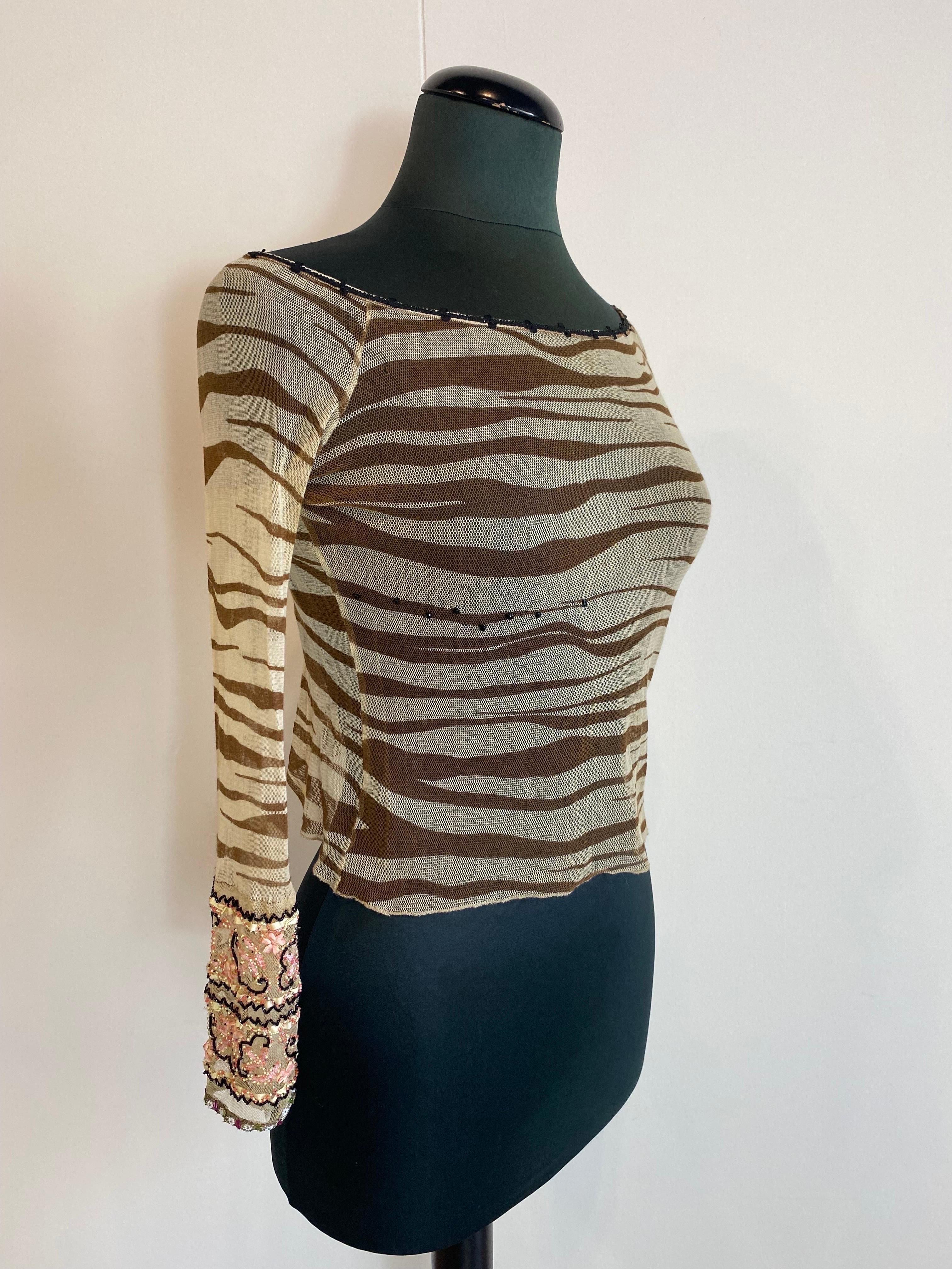 Blumarine zebra-print top with vintage beads
SS2000 collection.
Transparent. Beads along the sleeves as a workmanship. 
Composition label missing.
Cropped. Size 42Ita.
Length 36
Sleeve length 54
Bust 43
Shoulder 45
In good general condition, shows