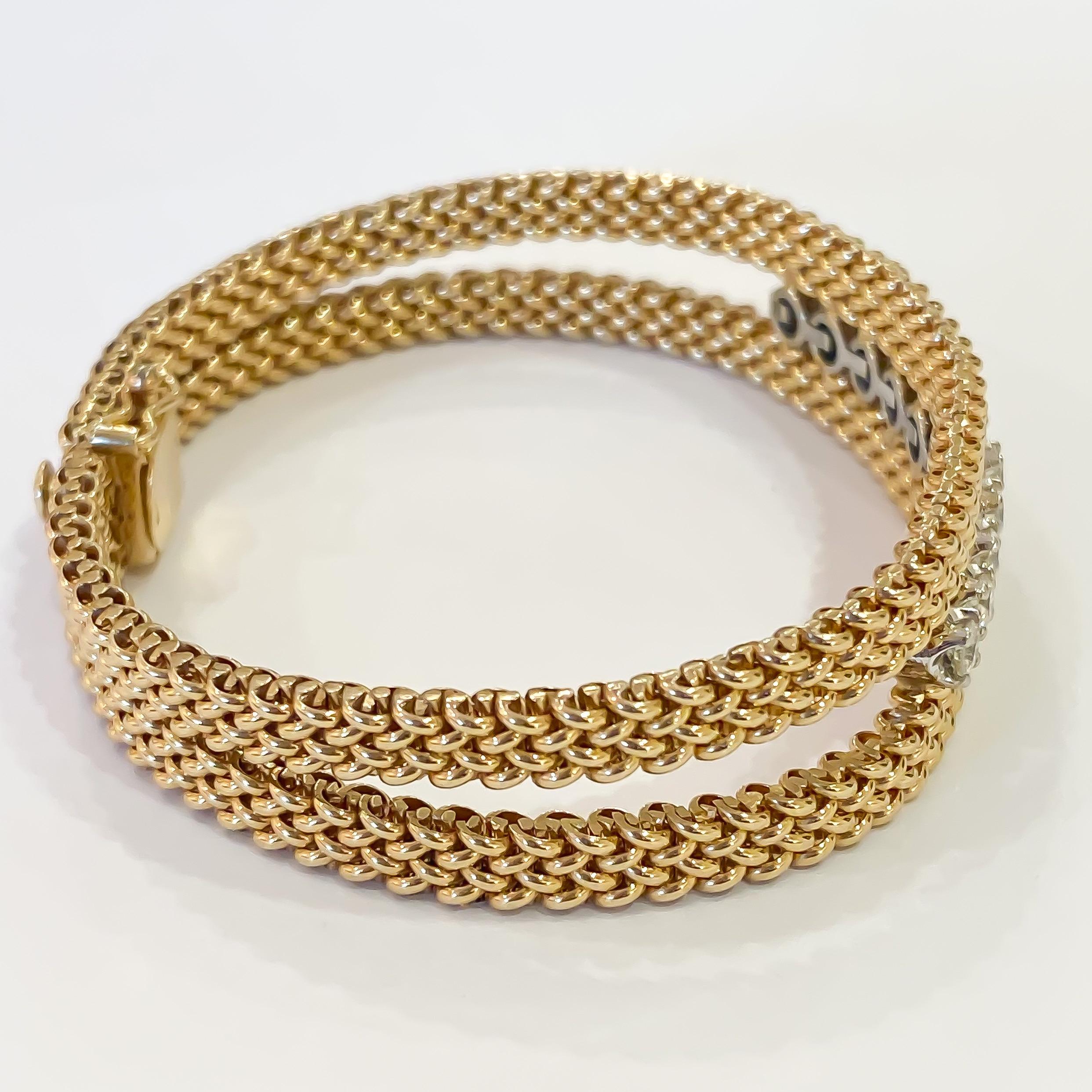 Estate diamond bracelet designed in 14 karat yellow gold. Two rows of intricate woven mesh set with ten round brilliant cut diamonds set in four prong heads. The bracelet measures 13.50mm at the widest point tapering to 9mm at the clasp. Each