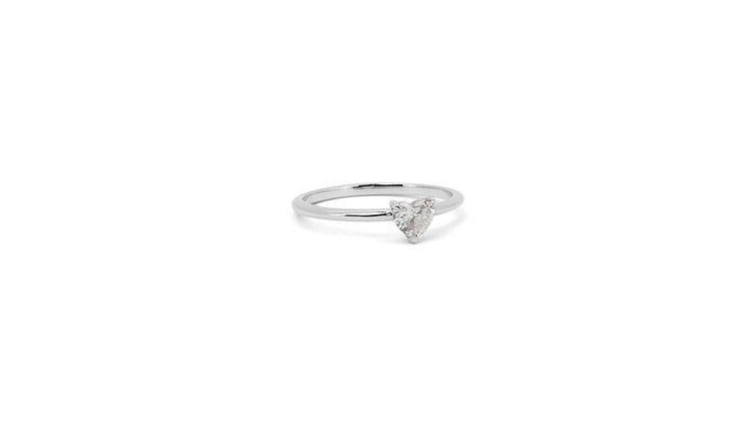 Unleash the power of love with this exquisite ring, featuring a mesmerizing 0.7-carat heart brilliant diamond. The captivating gemstone, meticulously cut to resemble a perfect heart, shimmers with brilliance and charm, nestled atop a radiant 18K