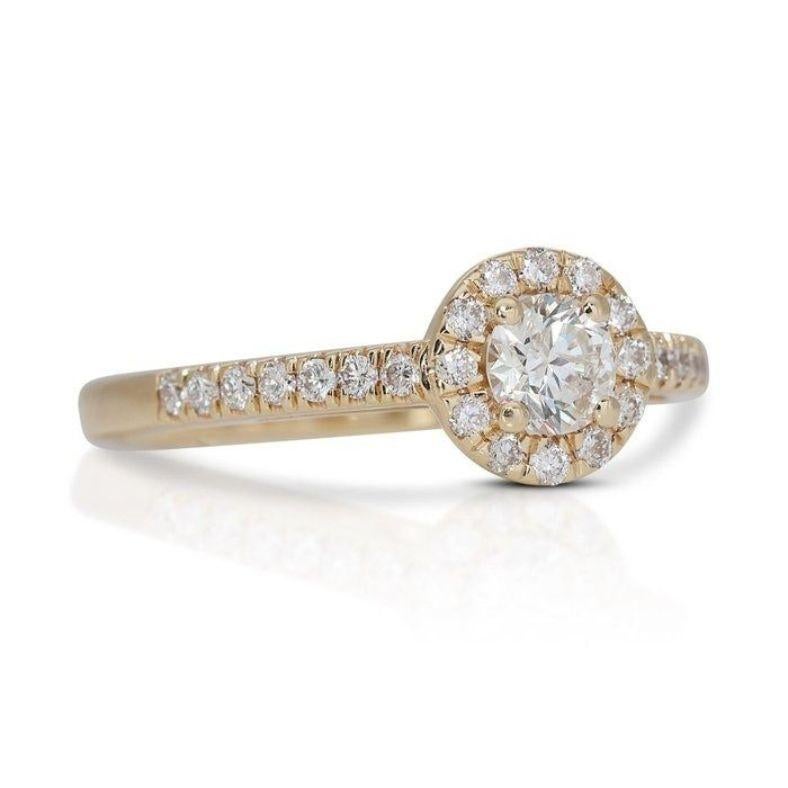 Imagine the sparkle that follows you everywhere with this exquisite ring. At its heart lies a dazzling 0.7 carat round brilliant diamond, boasting a warm H color (near colorless) and VS1 clarity (minute inclusions barely visible under 10x