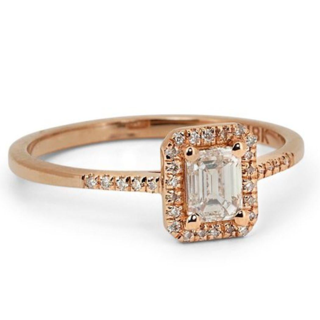 Embrace captivating sophistication with this breathtaking ring, showcasing a dazzling 0.7 carat emerald diamond, meticulously set in warm and romantic 18K rose gold. The exceptional D color (highest color grade!) guarantees unparalleled brilliance