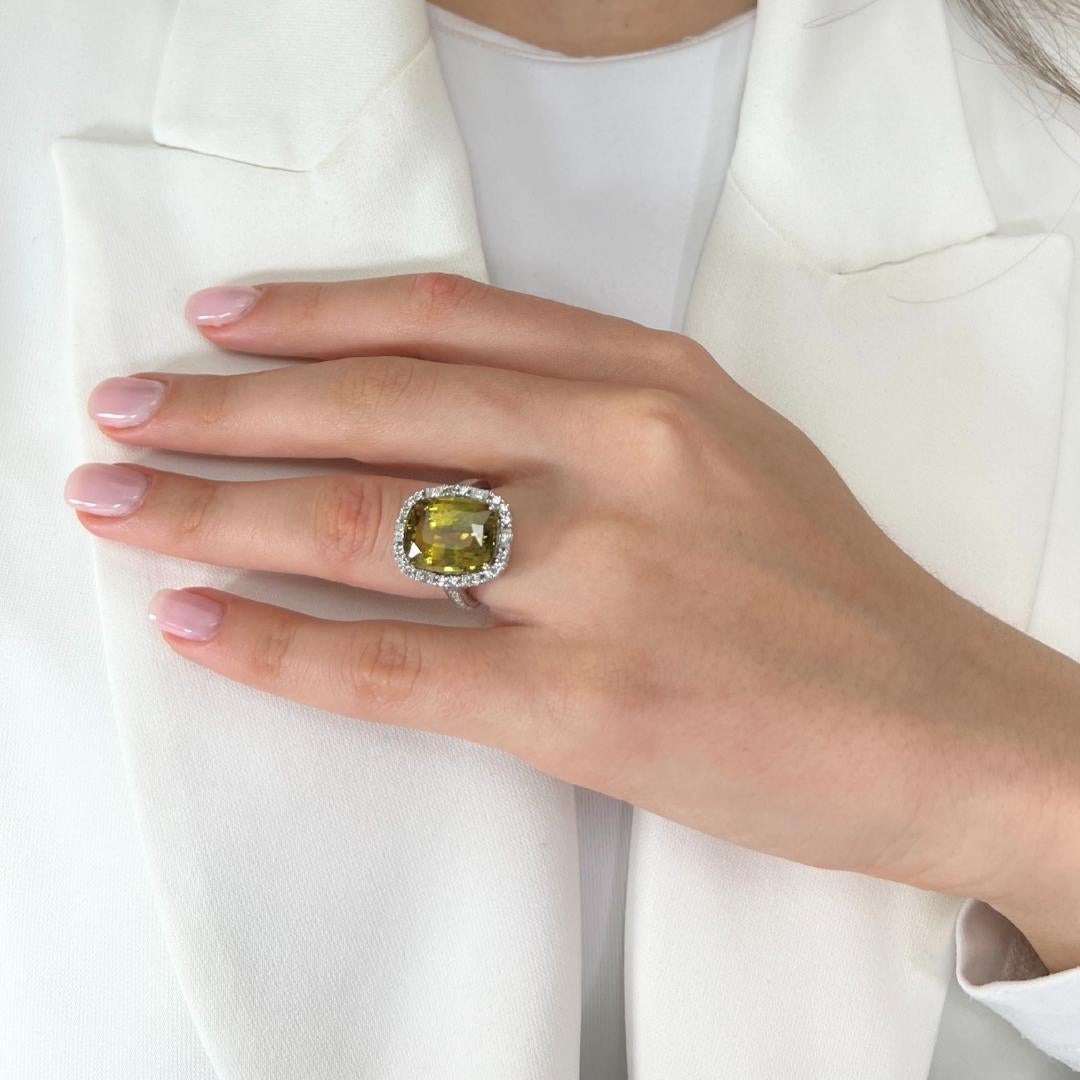 Mesmerizing 12.39ct Chrysoberyl and Diamonds Halo Cocktail Ring in 14k White Gold - GIA Certified

This captivating cocktail ring showcases an 11.64-carat cushion-cut chrysoberyl, glowing with a rare greenish-yellow hue. Nestled in luminous 14K