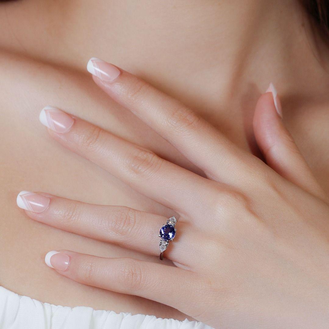 Introducing a breathtaking ring crafted from exquisite platinum, showcasing a mesmerizing tanzanite stone as the focal point. The round brilliant tanzanite weighs 1.89 carats and displays a captivating blue hue, evoking a sense of elegance and