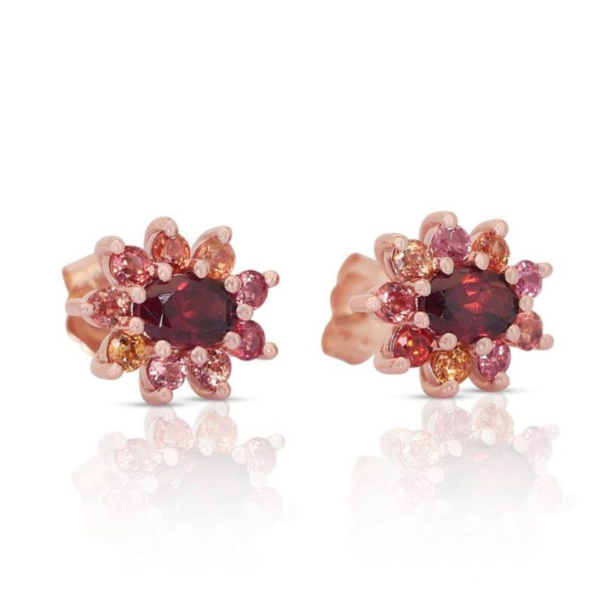 Gracing each earring is a mesmerizing oval-cut garnet, weighing 1.10 carats. The deep red hue of these main stones exudes warmth and sophistication, while their transparency allows light to dance within, illuminating their facets with a radiant