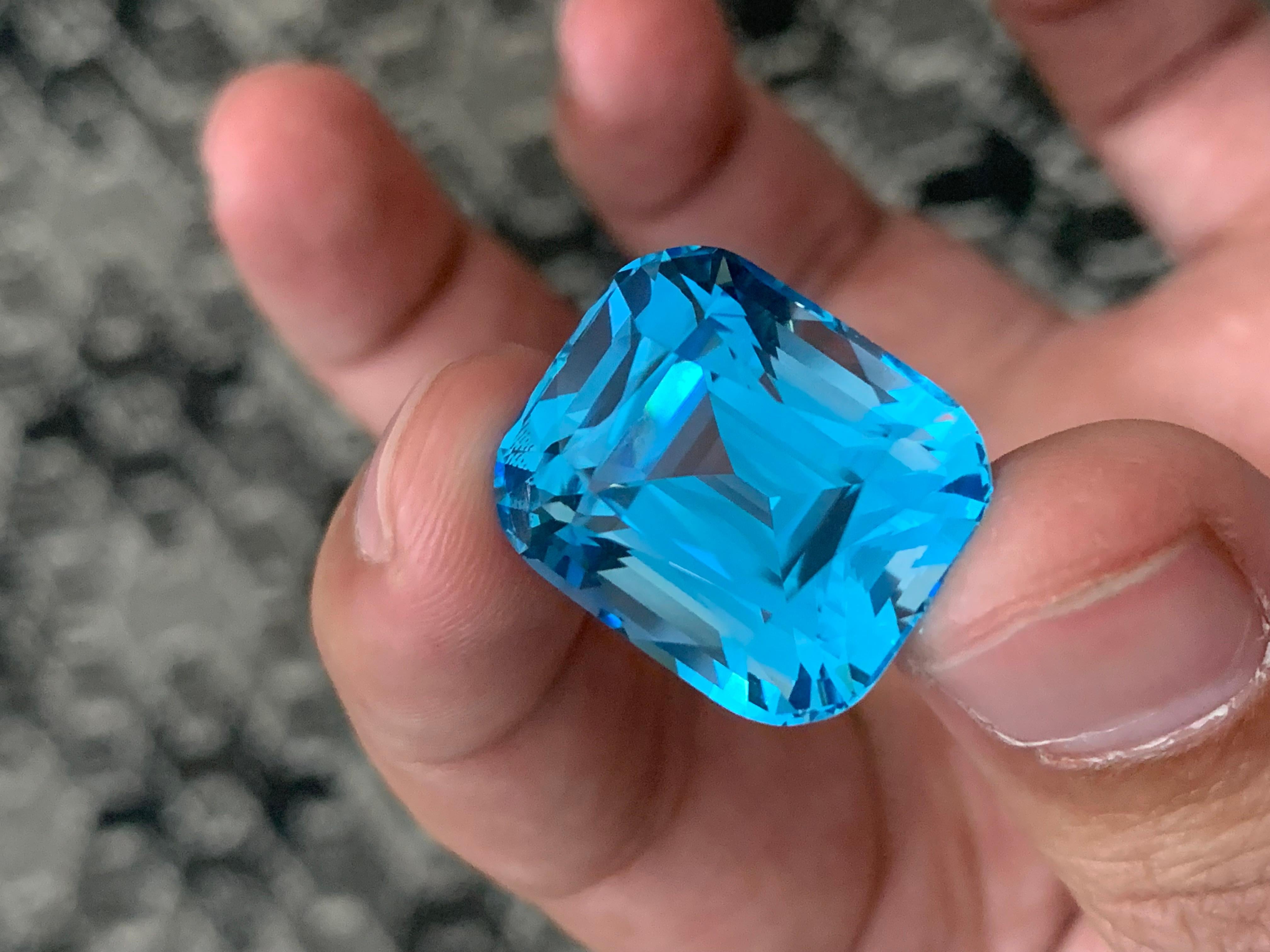 Swiss Blue Topaz
Weight: 44.80 Carats
Dimension: 20x17.3x14.8 Mm
Origin: Brazil
Certificate: On Customer Demand
Color: Dense Blue.

Swiss blue topaz is a stunning gemstone known for its vibrant, sky-blue hue. A member of the topaz family, it is