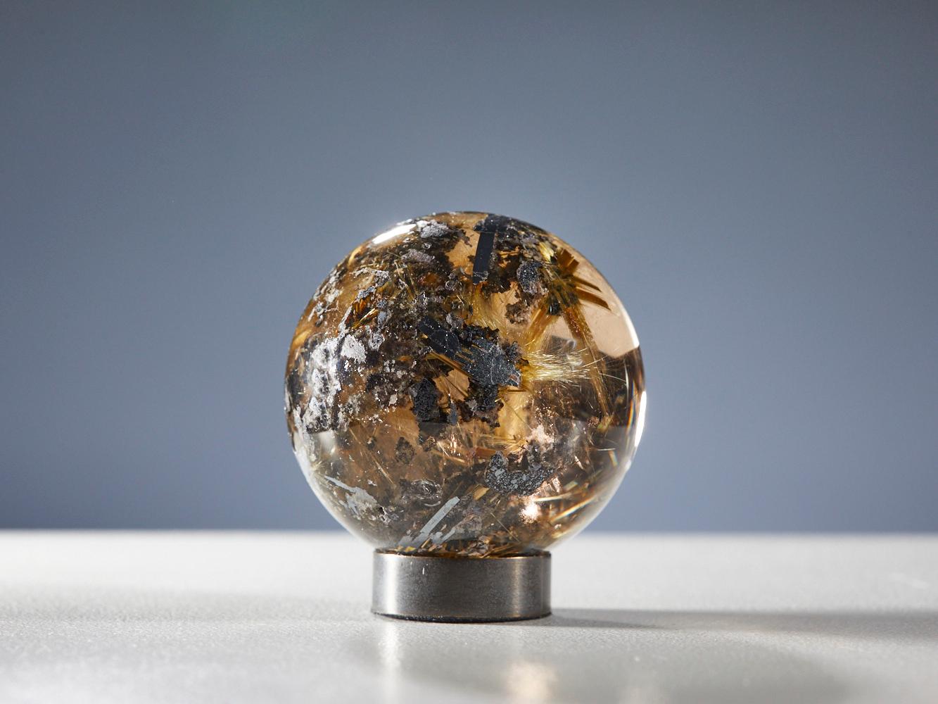 Bronze Mesmerizing Quartz Sphere with Golden Rutile Inclusions For Sale