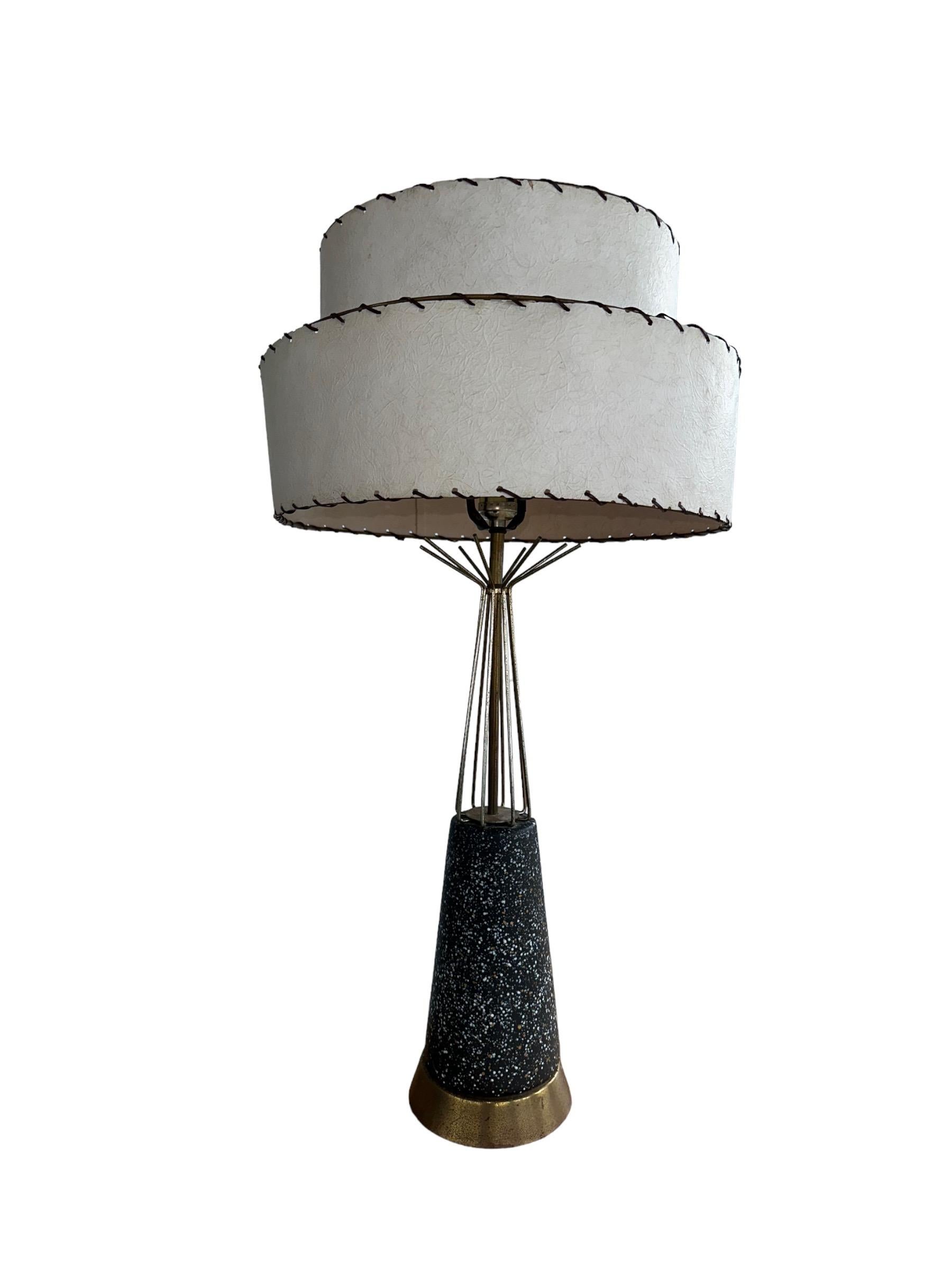 Unique and brilliant Mid-Century Modern tall table lamp. In very good even original vintage condition, and presents well. Hand painted speckled tapered base, brass, bent rod neck, and original two tiered fiberglass round shade. Beautiful on or off,