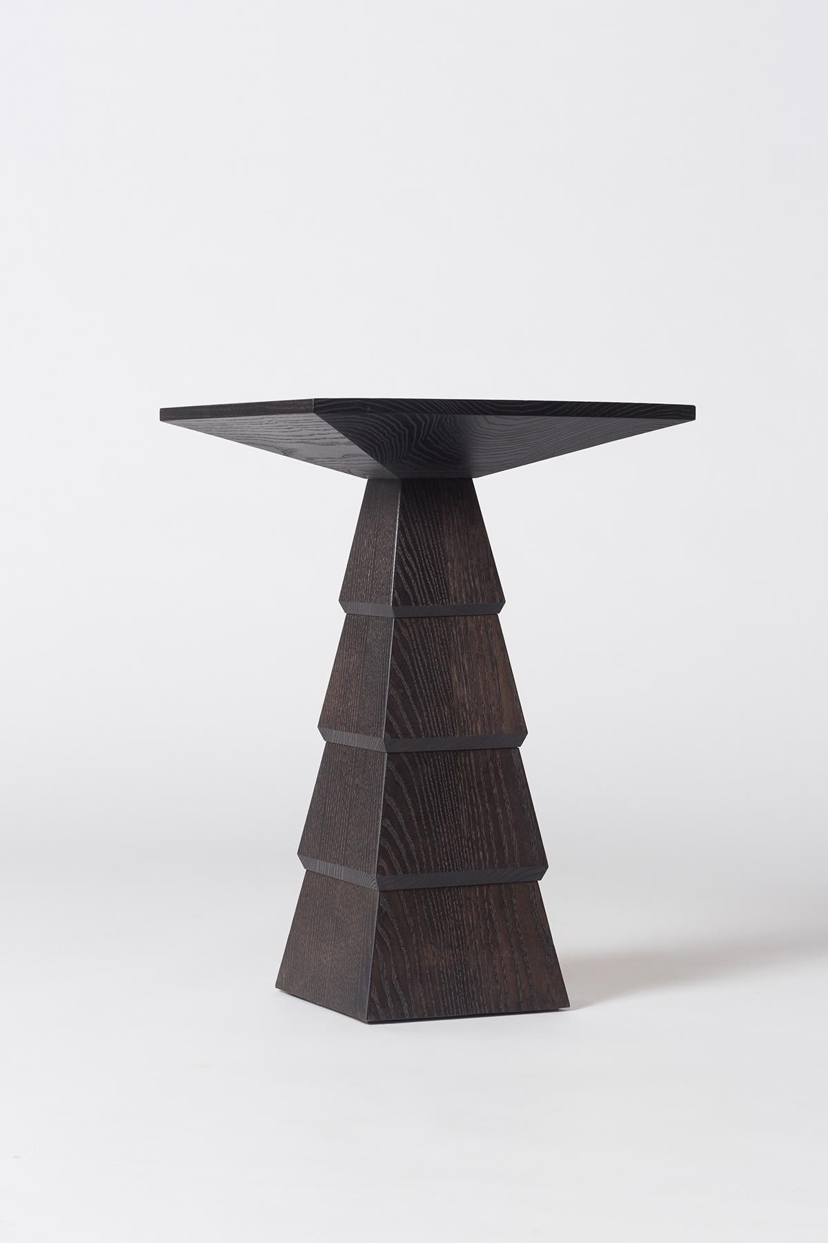Measures: L 16in (41cm) x W 16in (41cm) x H 24in (61cm).

Inspired by the architecture of Frank Lloyd Wright, the Meso tables are Brutalist in shape with rich and contrasting woods. Available in ebonized ash.