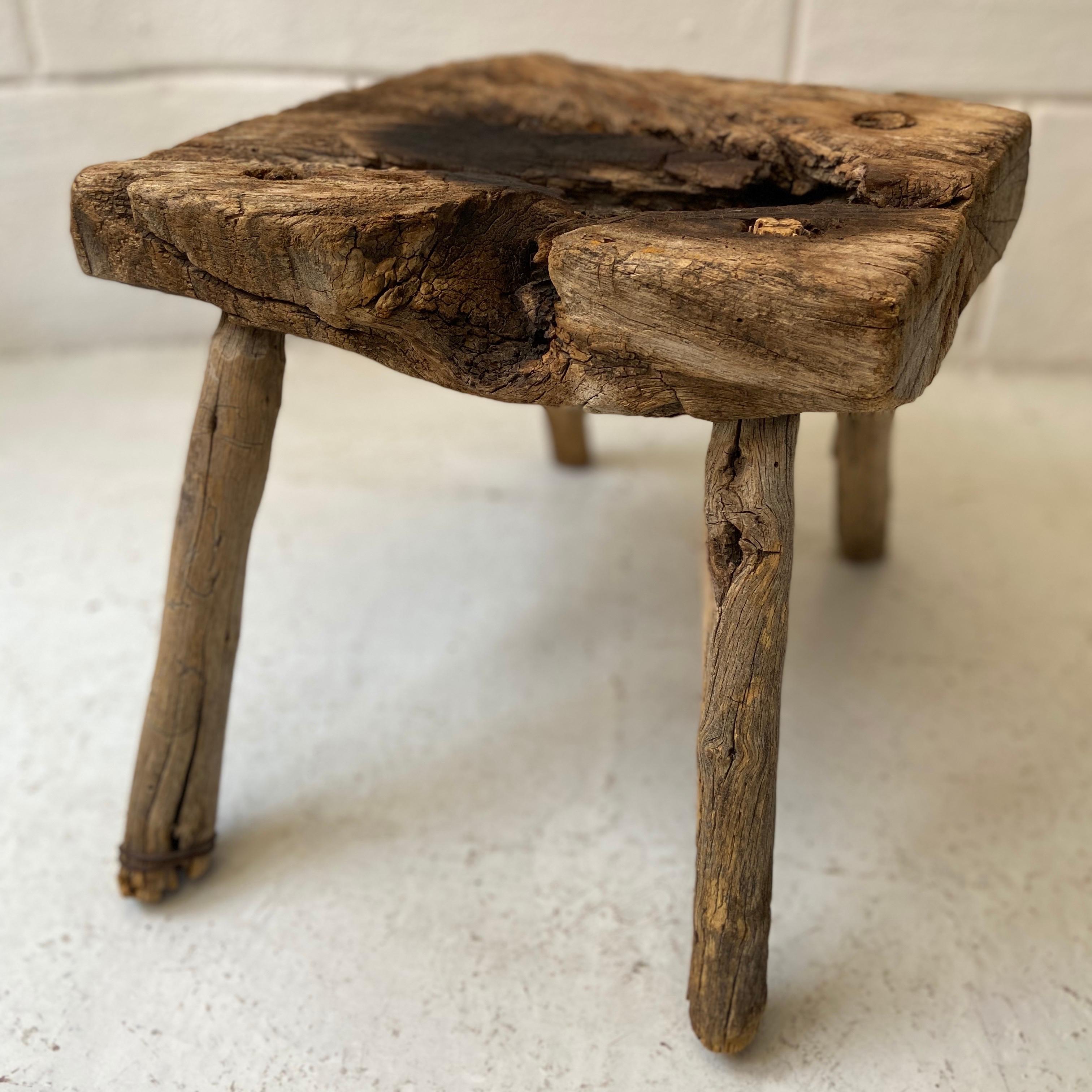Four legged mesquite stool from Northern Jalisco, Mexico. Partially burnt on the seat. Beautiful character. Restored with all original parts.