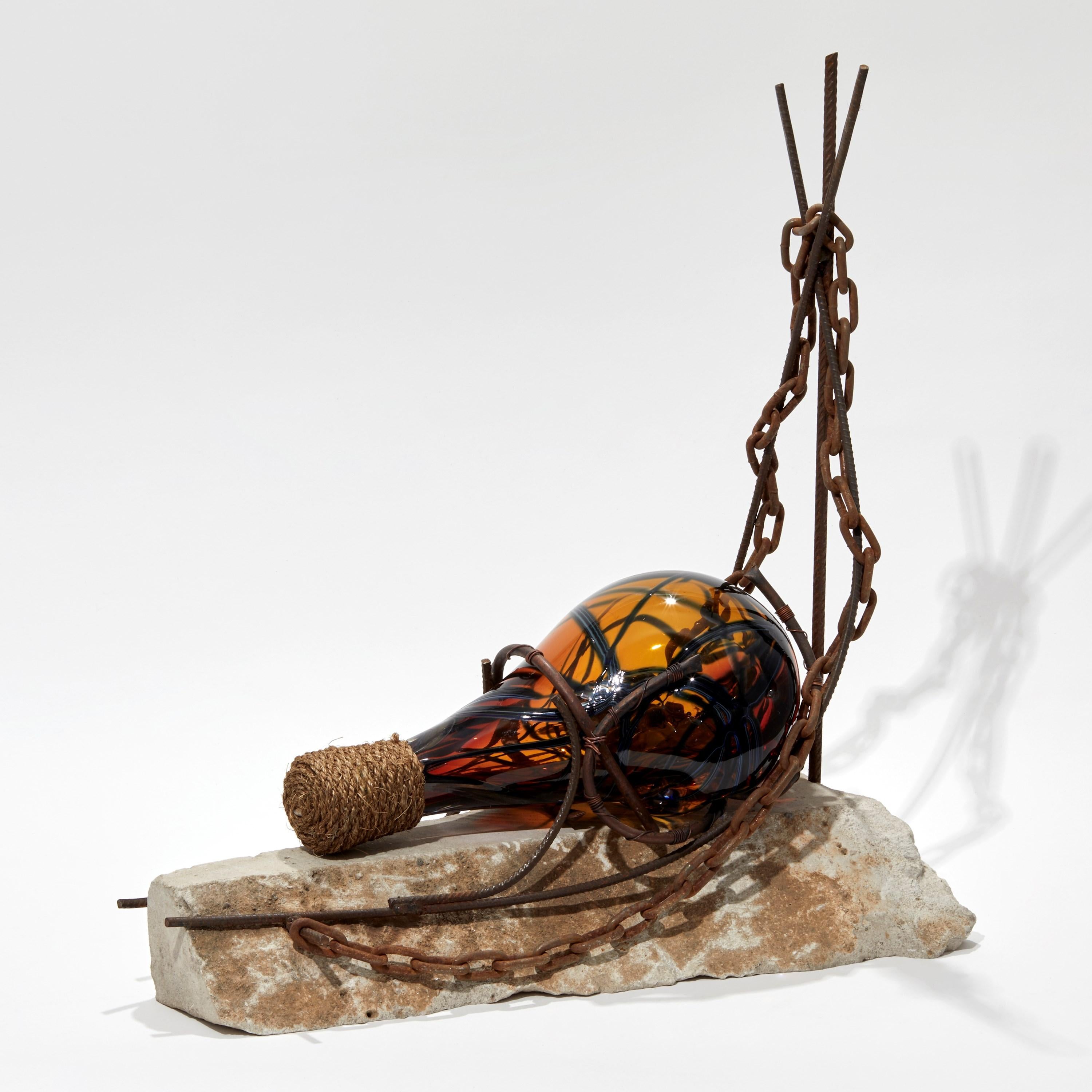 'Message in a Bottle' is a unique sculpture by the British artist, Chris Day, created from handblown and sculpted glass, micro bore copper pipe, copper wire, steel rebar, chain and reclaimed limestone.

This artwork was created as part of the