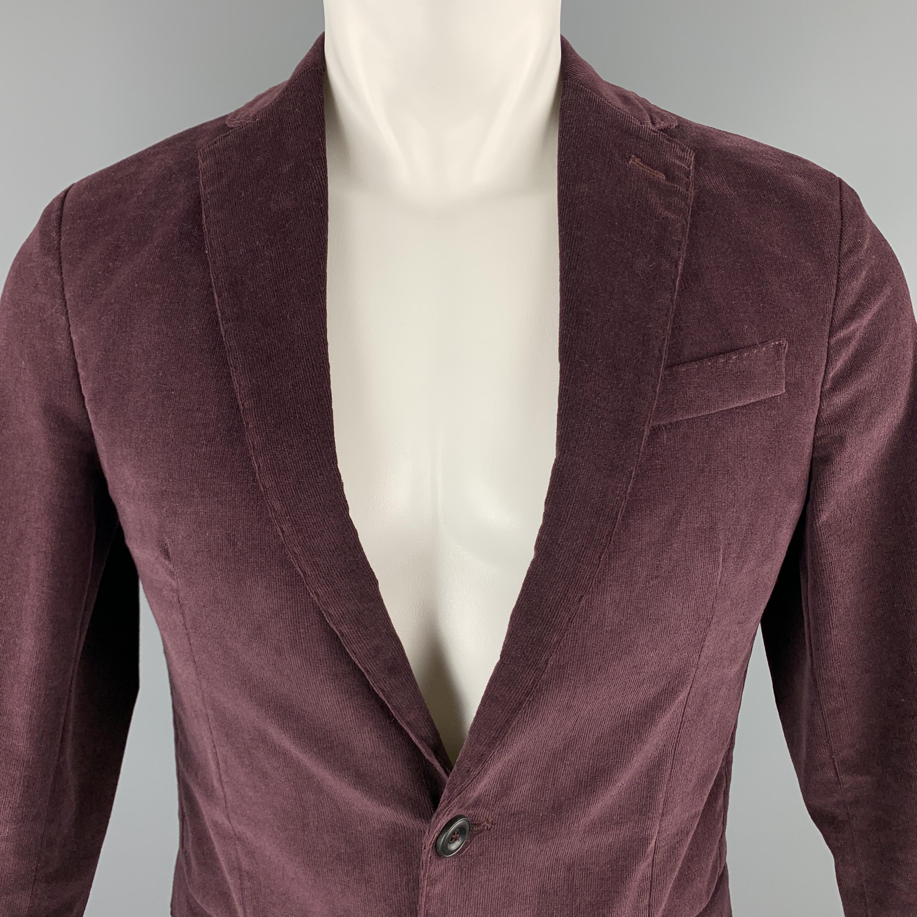 MESSAGERIE sport coat comes in a solid burgundy cotton / elastane corduroy material, featuring a notch lapel, slit and flap pockets, two buttons at closure, single breasted, buttoned cuffs, a double vent at back, unlined. Made in Italy. 

Excellent