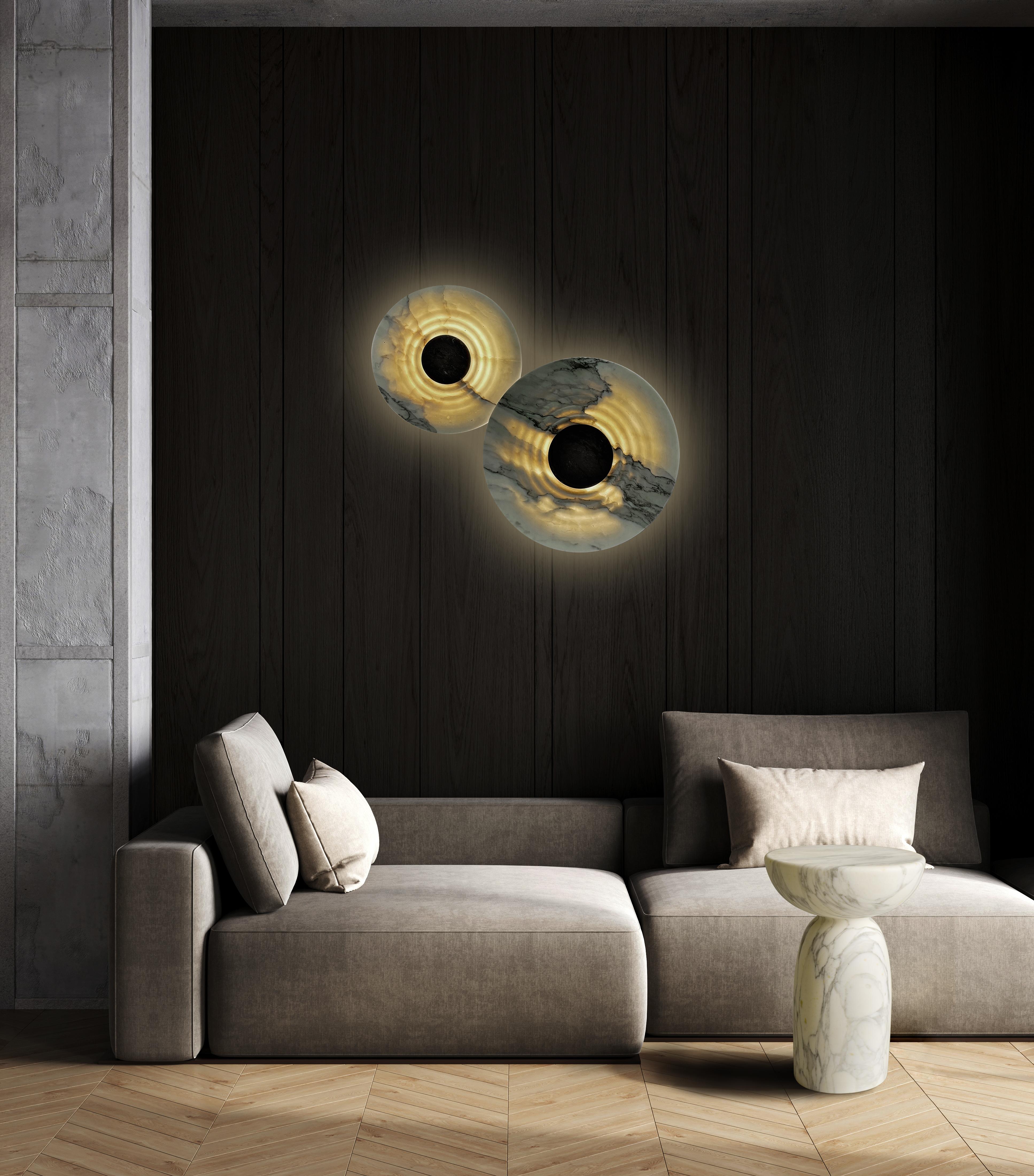 Messier marble sconces are both lighting fixtures and sculptures.

Named after the French astronomer Charles Messier and masterfully crafted in Italy with Calacata marble, Messier evokes the biggest mystery in the history of our universe. Creators