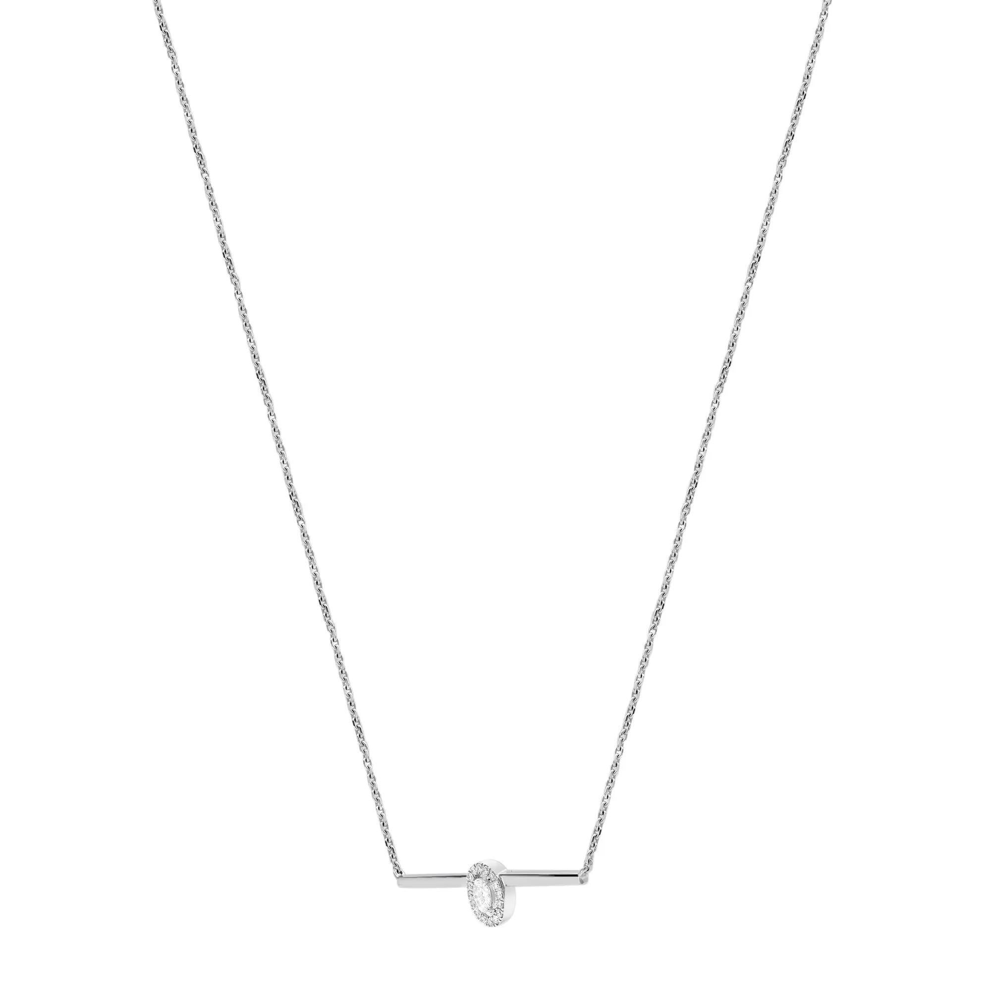A chic and modern, Messika Glam'Azone diamond bar necklace crafted in lustrous 18K white gold. Showcasing a center prong set oval cut diamond with a round cut halo bar chain necklace. Total diamond weight: 0.22 carat. Diamond color G and clarity VS.