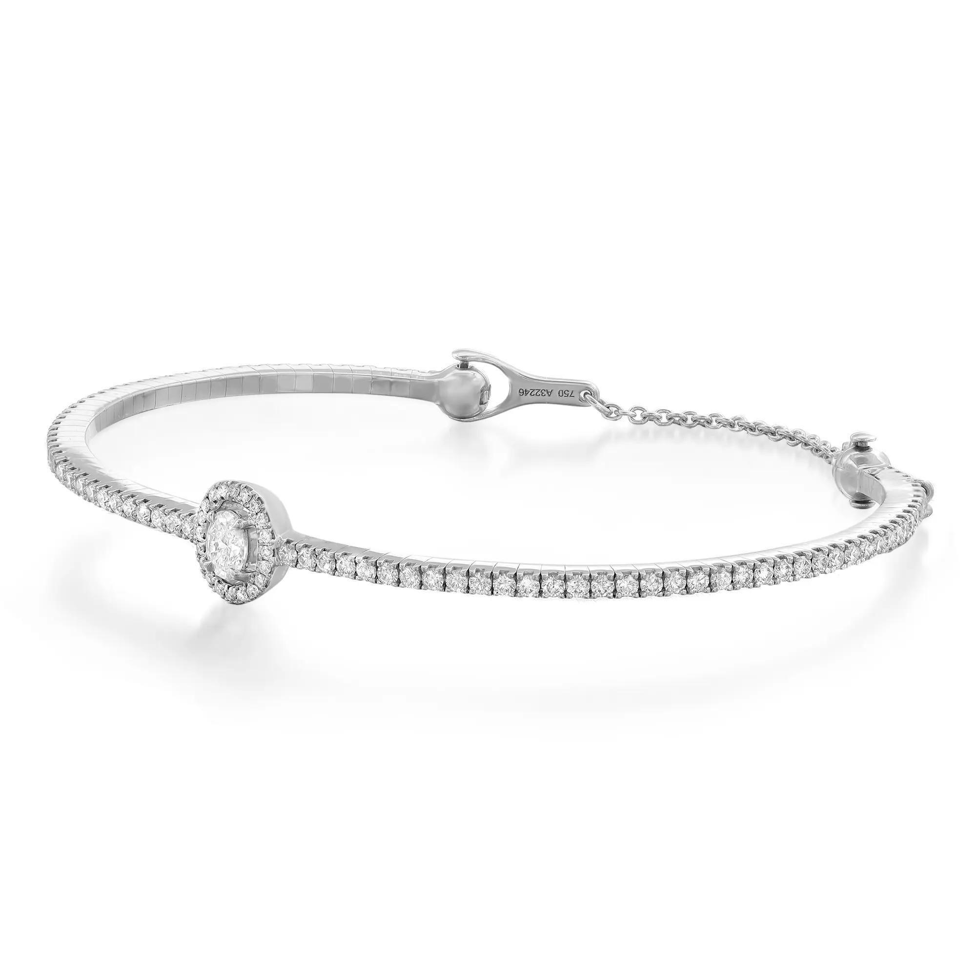 Sparkle all way with this beautiful Messika Skinny Glam'Azone diamond bracelet. Crafted in lustrous 18K White Gold. This glamorous bangle bracelet is adorned with a center prong set oval cut diamond and accented with round brilliant cut diamonds all