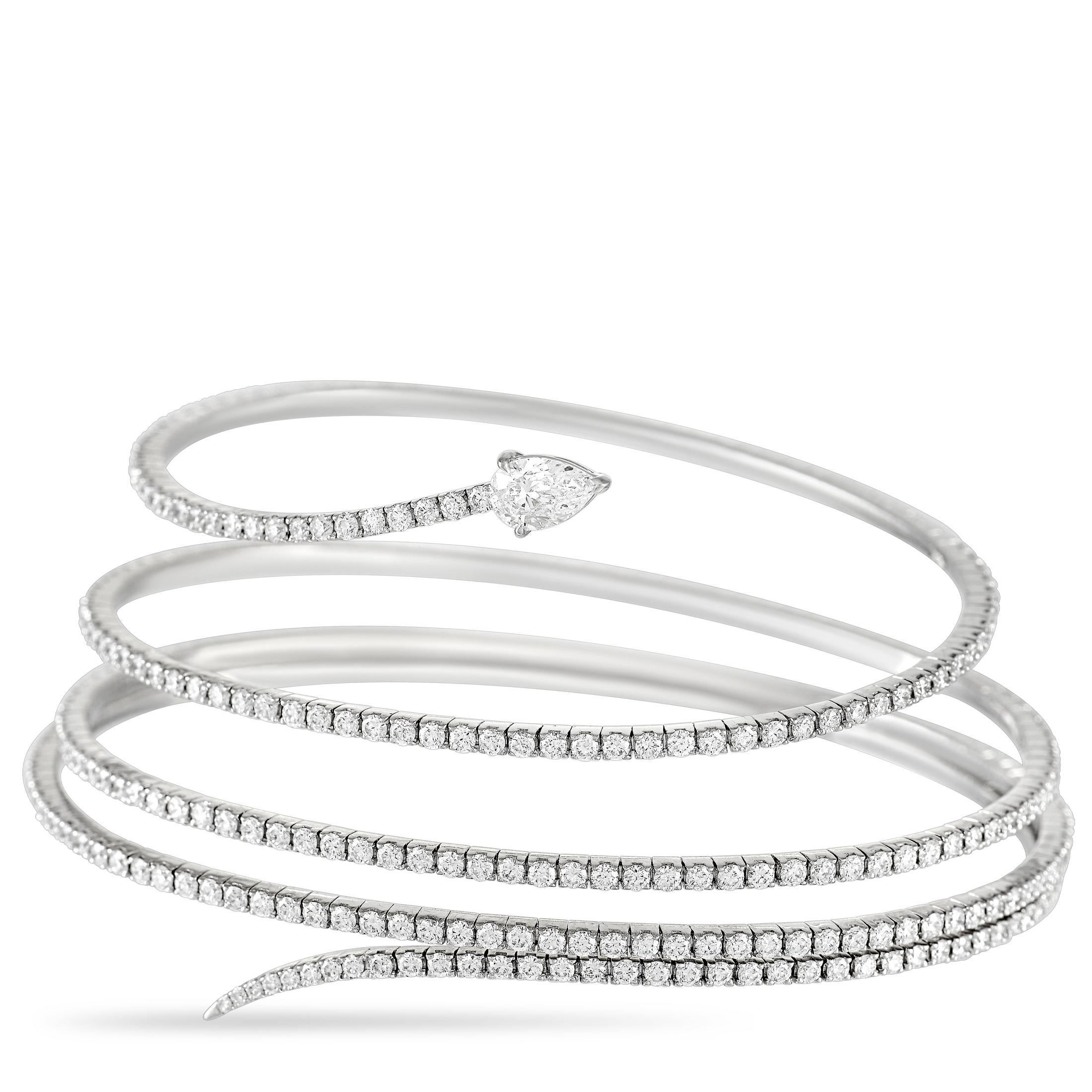 All eyes are sure to be on this beautiful Messika bracelet. The bracelet is made with a thin band of sleek 18K white gold that wraps around the wrist five times. The bracelet is fully set with a 3.89 carat row of round-cut diamonds over its length.