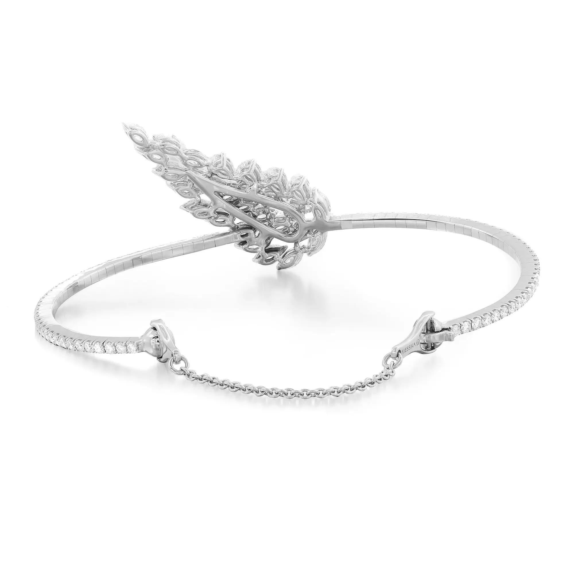 This stunning and exemplary Messika Angel Skinny bangle bracelet is crafted in highly polished 18K white gold. Starring sparkling prong set pear and marquise cut diamonds in a leaf pattern accented with round brilliant cut diamonds around the