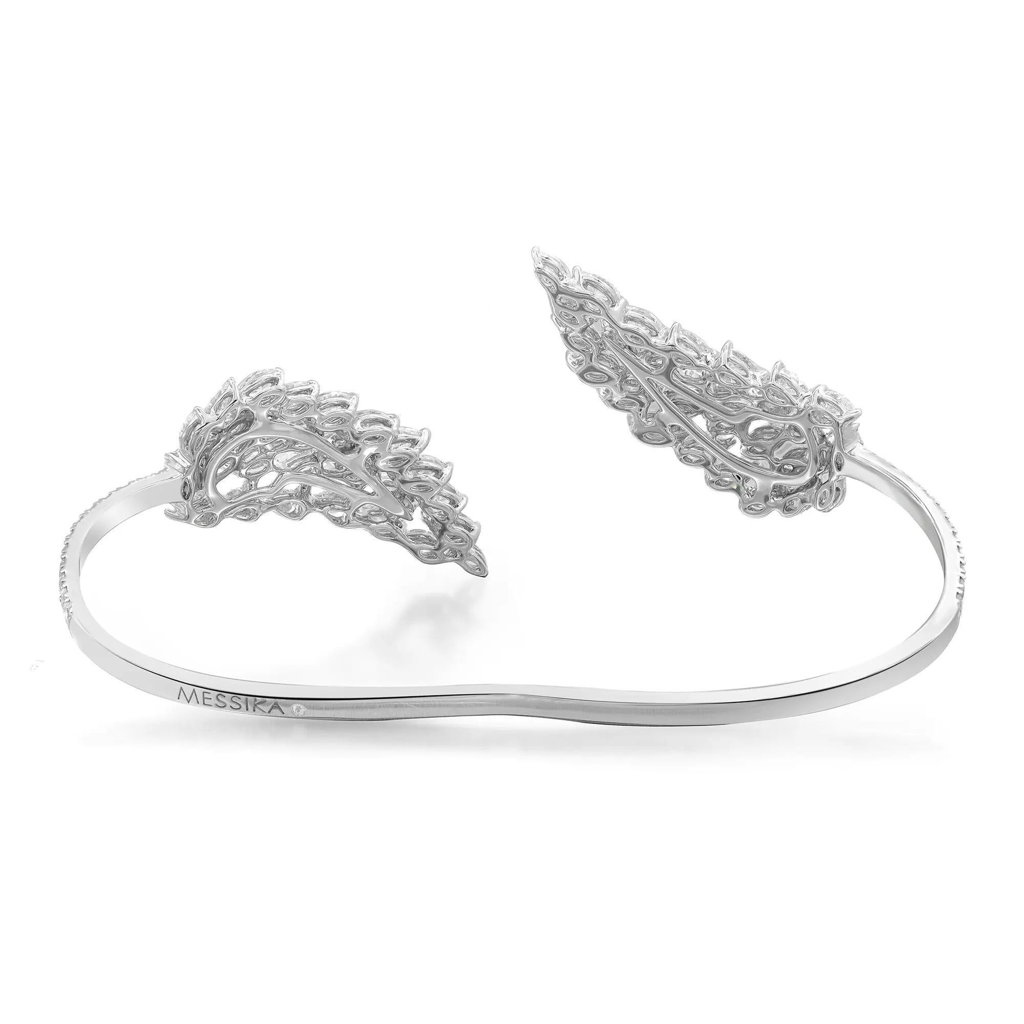 This gorgeous Messika Angel Double diamond bracelet exudes sophistication. Stunningly crafted in lustrous 18K white gold. It features wing-shaped tips that glisten with prong set sparkling marquise and pear cut diamonds with round brilliant cut
