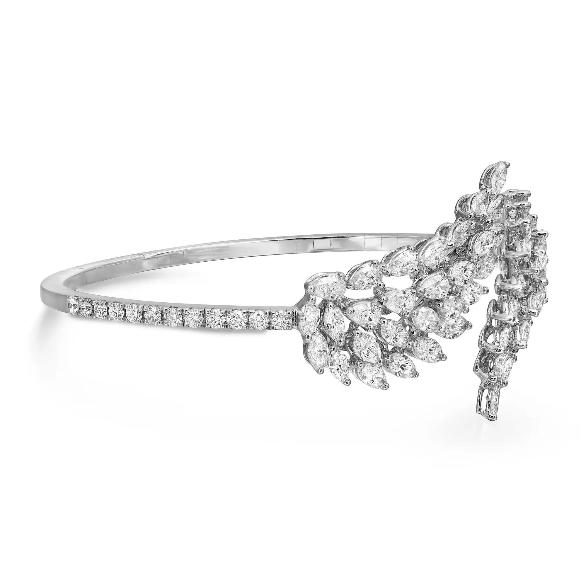 This gorgeous Messika Angel Double diamond bracelet exudes sophistication. Stunningly crafted in lustrous 18K white gold. It features wing-shaped tips that glisten with prong set sparkling marquise and pear cut diamonds with round brilliant cut