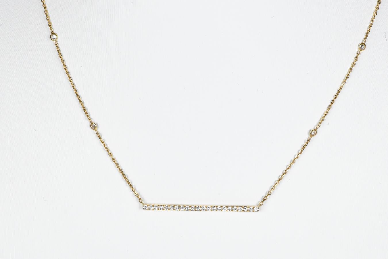 18K yellow gold necklace set with a total of 27 round brilliant diamonds. Including 22 of 0.015 carats on the horizontal pendant. 4 diamonds of 0.02 carats on the chain. And 1 diamond, 0.01 carats, on the pierced clasp pendant. The diamonds total
