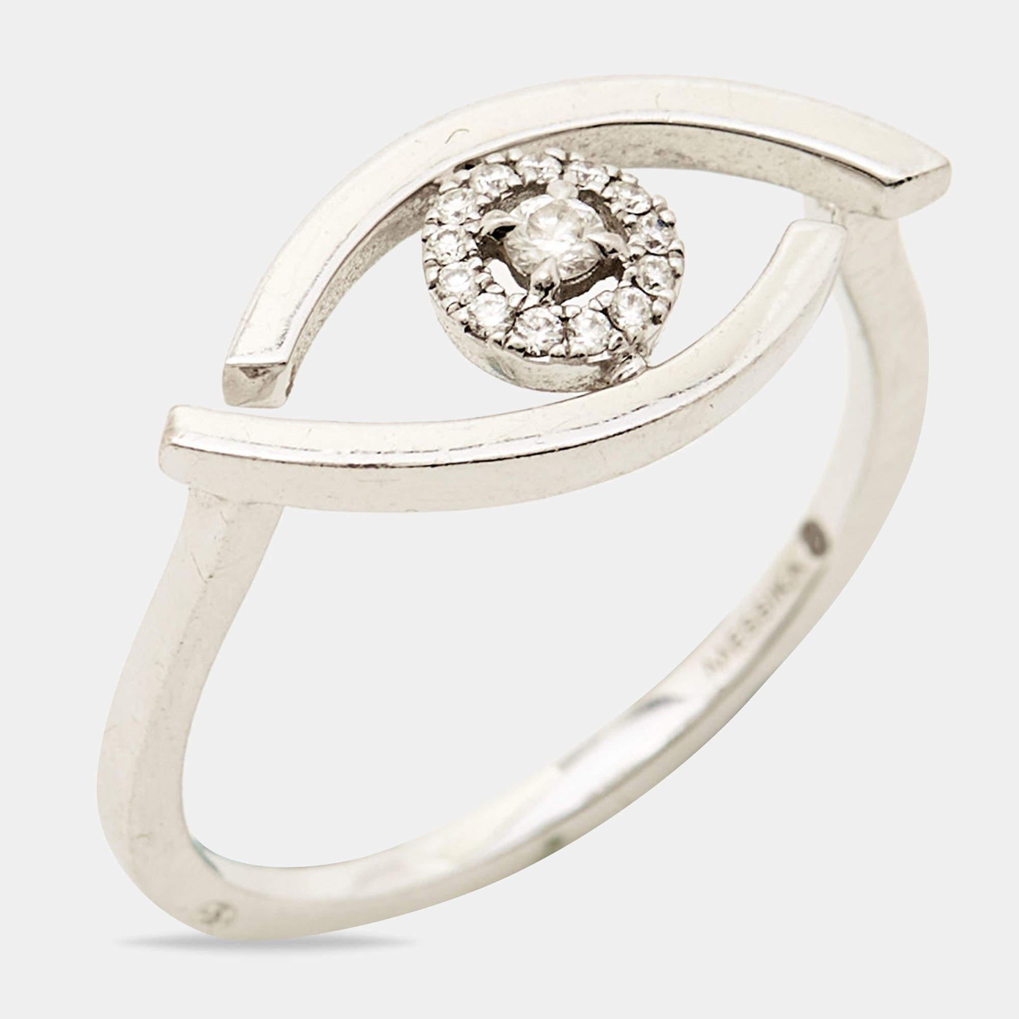 The Messika Lucky Eye ring is a stunning piece of jewelry that effortlessly blends elegance and symbolism. Crafted in luxurious 18k white gold, the ring features a mesmerizing 
