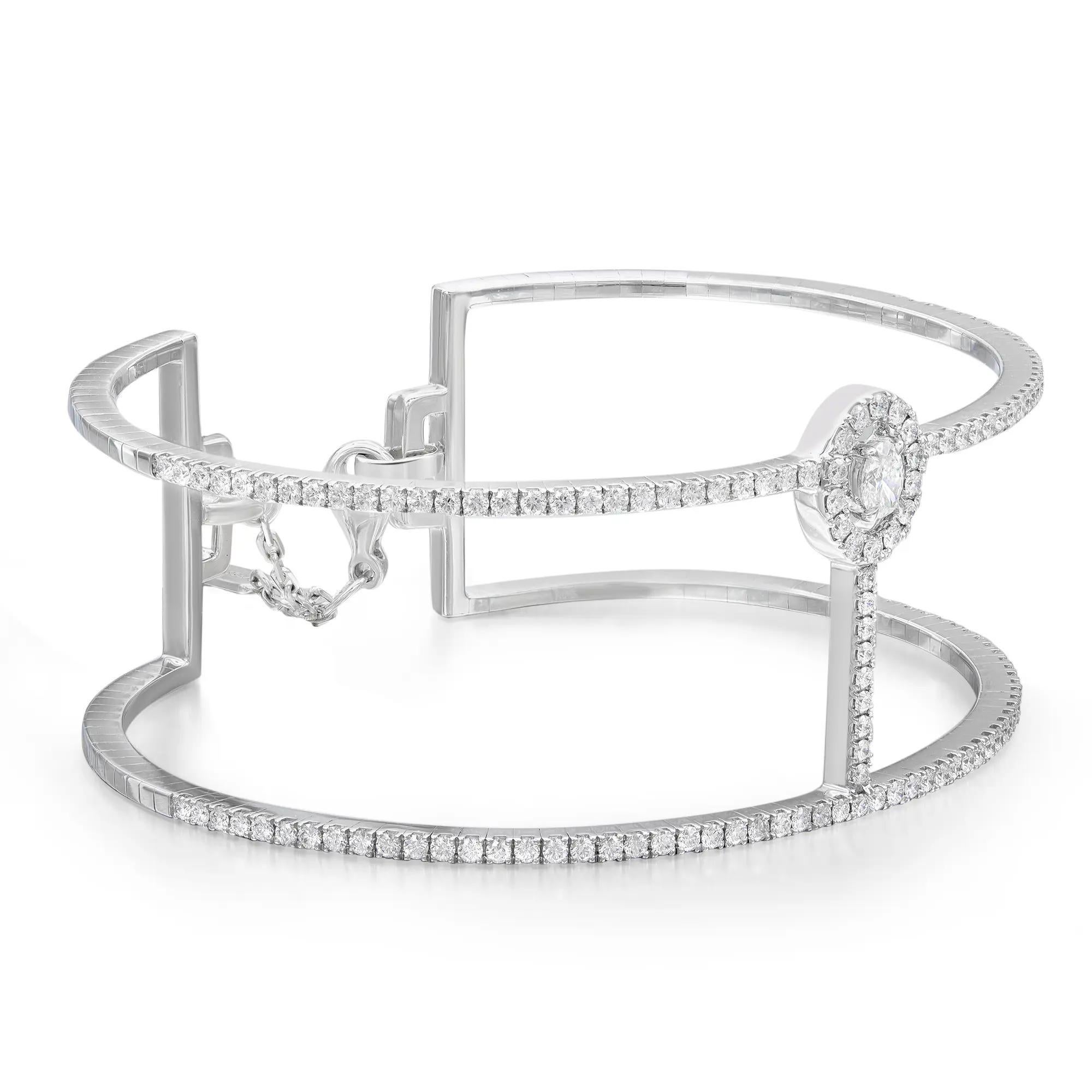 Add a touch of sparkle to your wrist with this gorgeous Messika Manch Glam'Azone diamond 2 rows cuff bracelet. Crafted in lustrous 18K white gold. It features center prong set oval cut diamond accented with round brilliant cut diamonds halfway