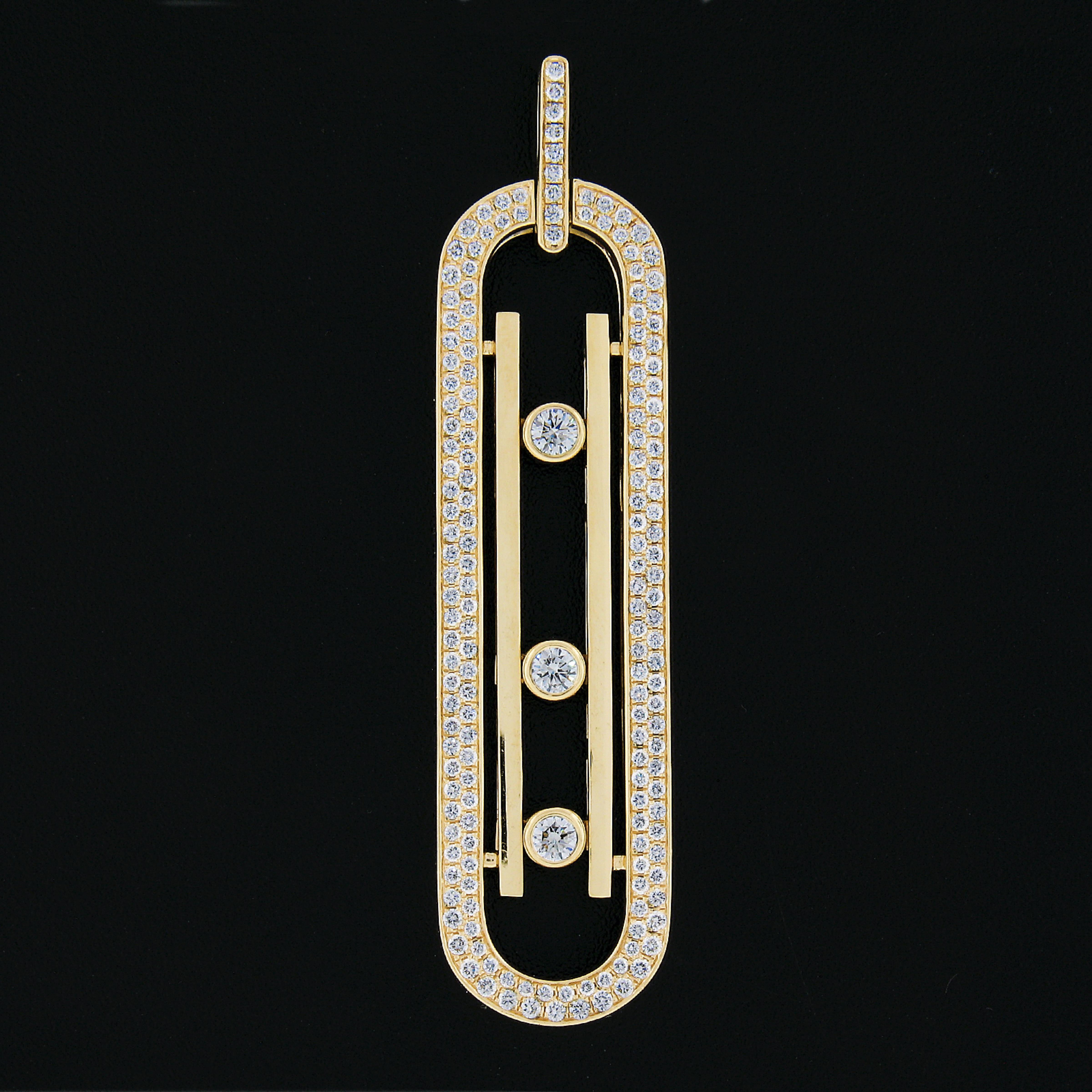 Here we have a beautiful large oval bar pendant by MESSIKA that is crafted in solid 18k yellow gold. This beautiful design features a numerous pave set diamonds around the frame, the open center have 3 moving diamonds which slide & move within the
