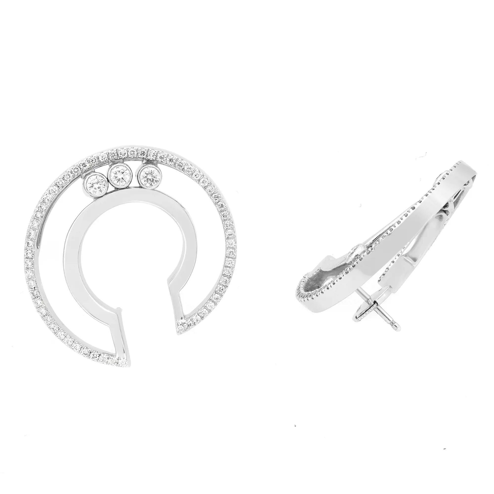 These glamorous diamond hoop earrings feature pave set round brilliant cut diamonds with 3 bezel set moving diamonds weighing 0.80 carat. Encrusted in lustrous 18K white gold. Diamond quality: color G and clarity VS. Hoop diameter: 1 inch.