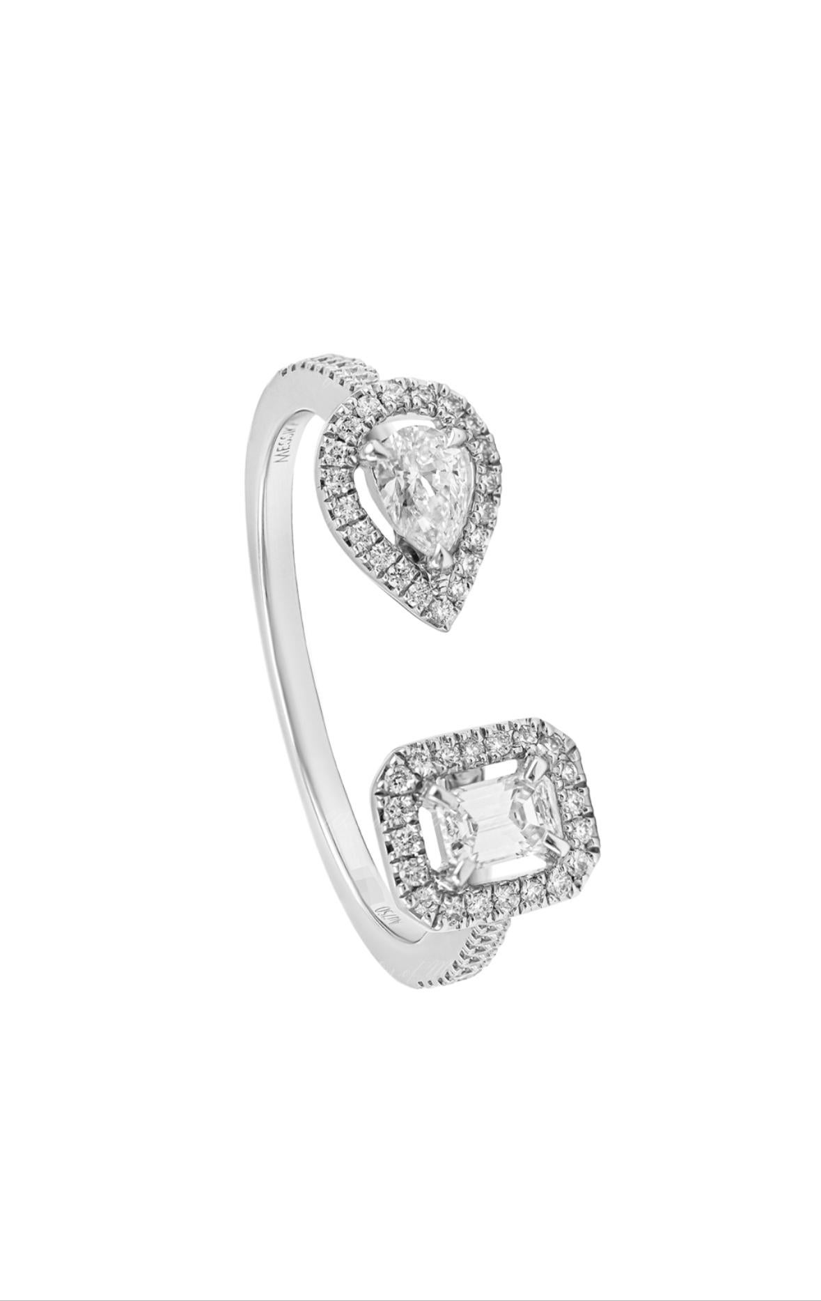 From Messika My Twin Collection. Playing with a horizontal motif and a vertical one, this 18K white gold open band wraps the finger with a glittering light, uniting an emerald-cut diamond and sparkling pear-cut diamond. Enhanced by a delicate
