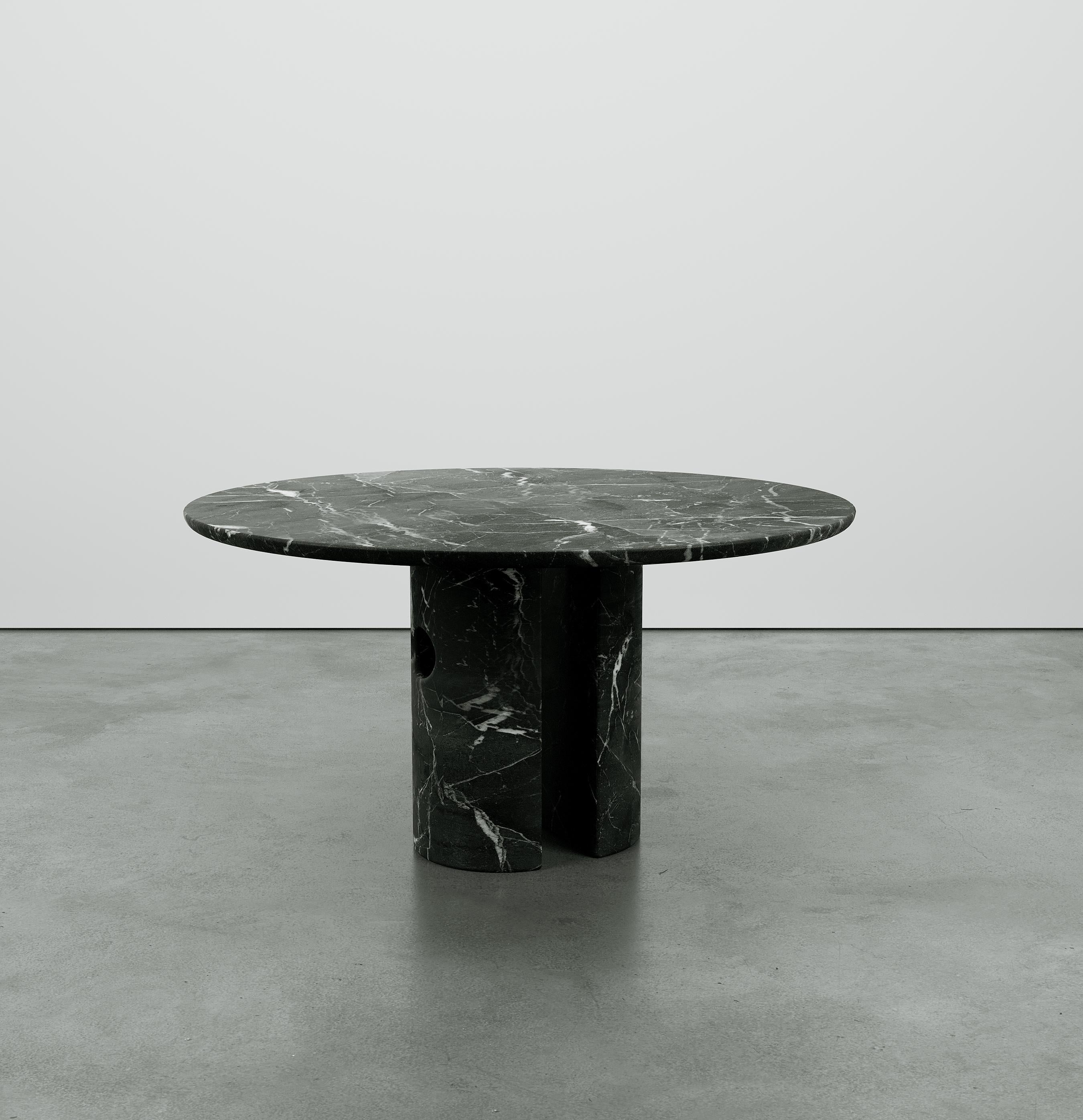 Inspired by Euclidean geometry, the Meta table expresses a balance of simplicity and elegance that evokes a combination of raw and primitive qualities. The monolithic style legs are cut from a single block of stone to form two semi-circular columns
